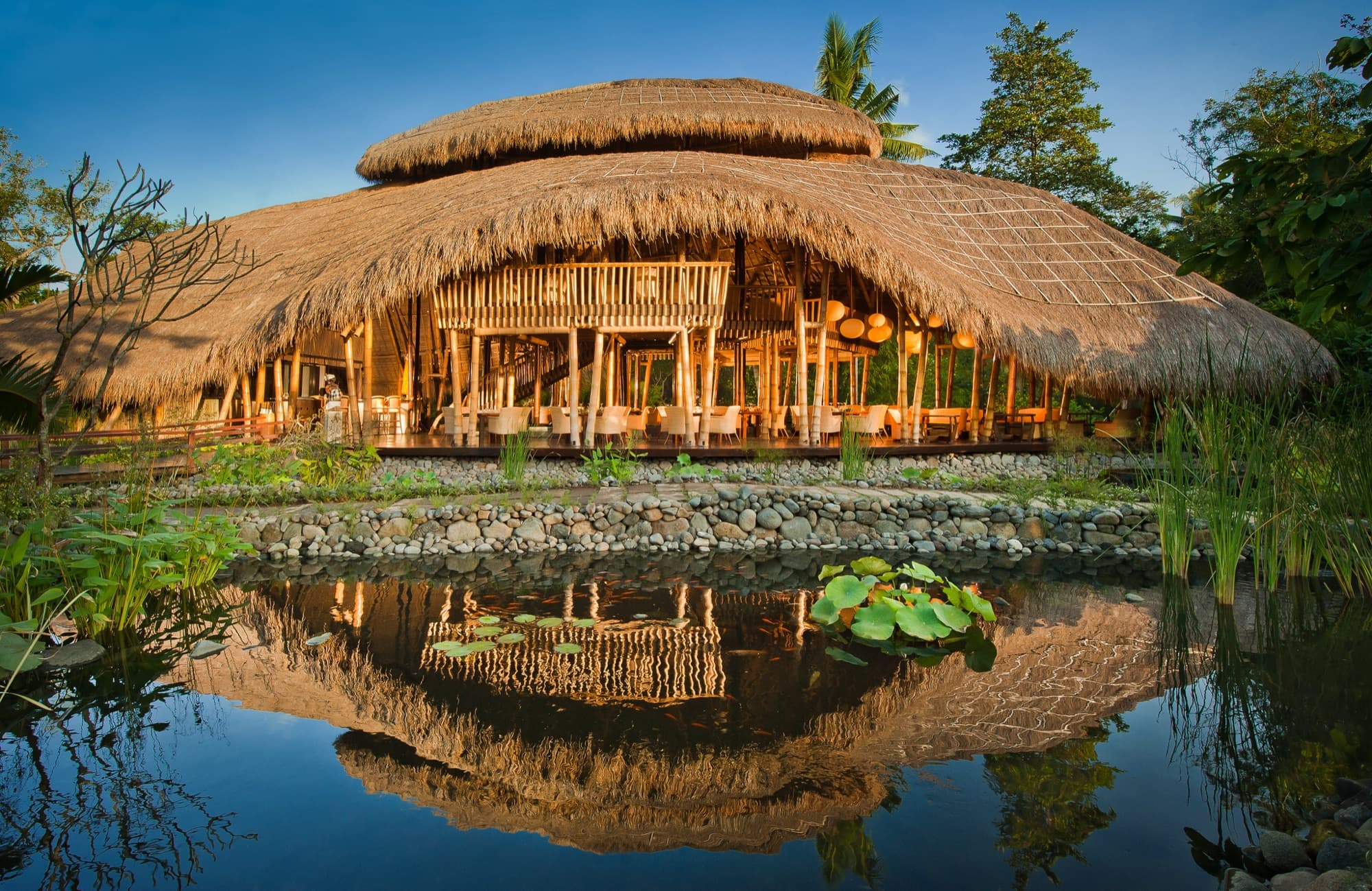 Sakti Dining Room bamboo structure reflected in the lotus pond