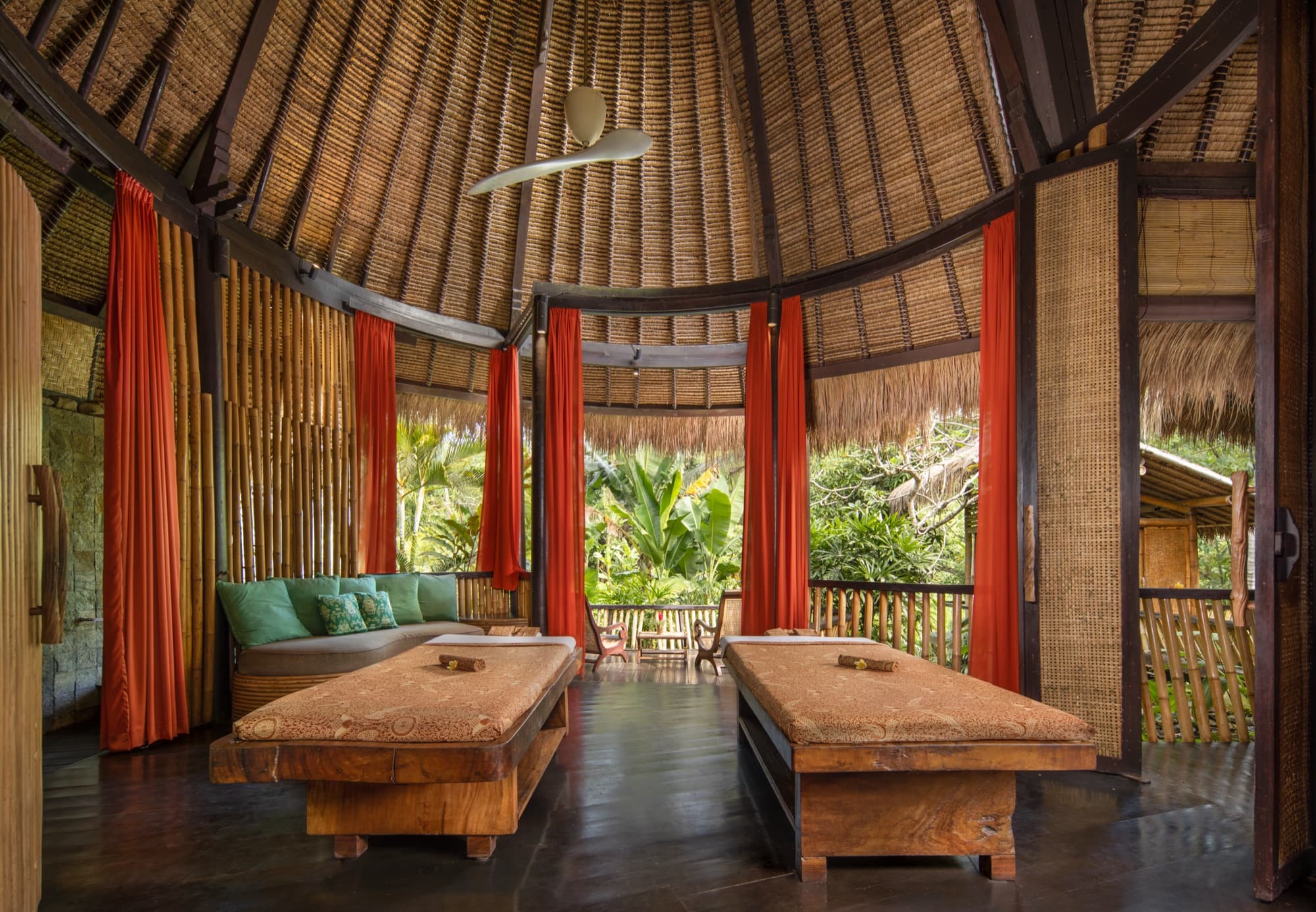 Treatment pavilion with wooden tables and red curtains