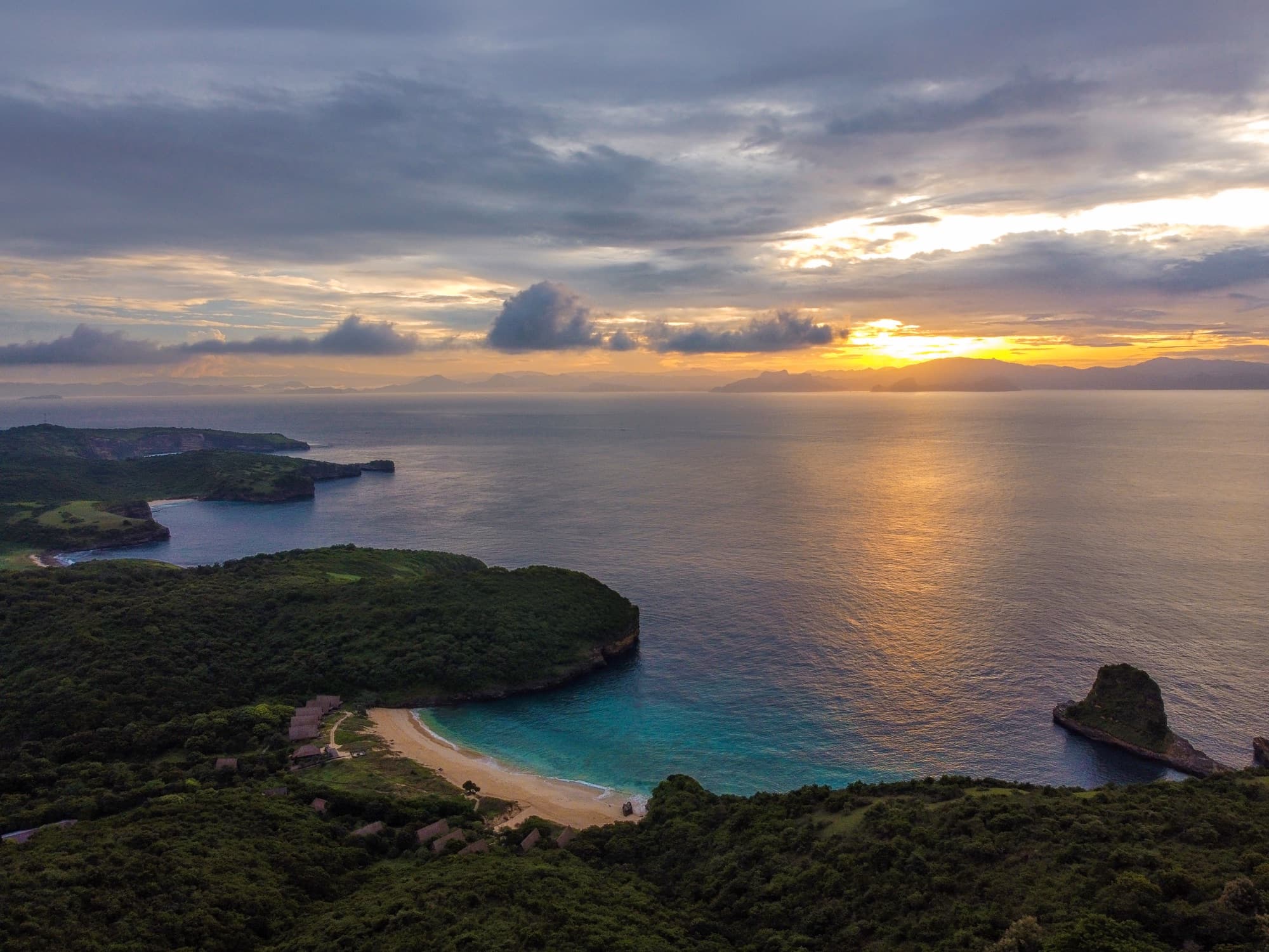 Aerial view of the Tanjung Ringgit peninsula — turquoise Indian Ocean, cliffs and undeveloped coastline, south Lombok