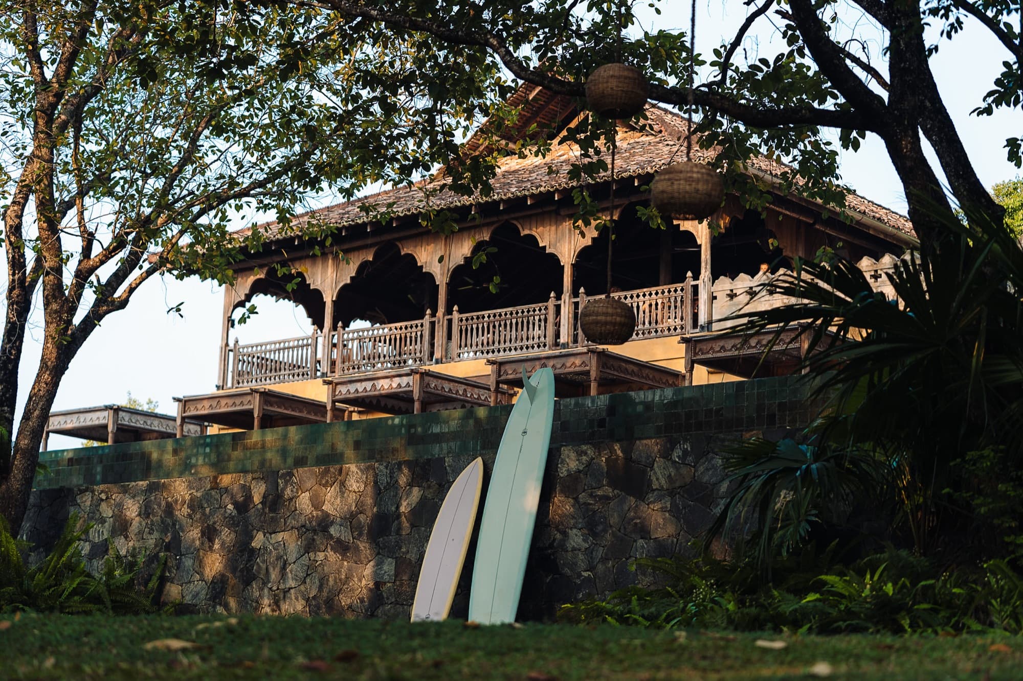 Surfboards leaning below the timber pavilion on the estate