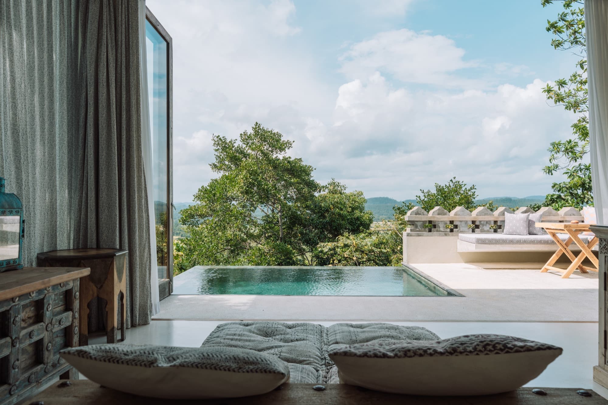 Private plunge pool opening onto the forested valley from the villa