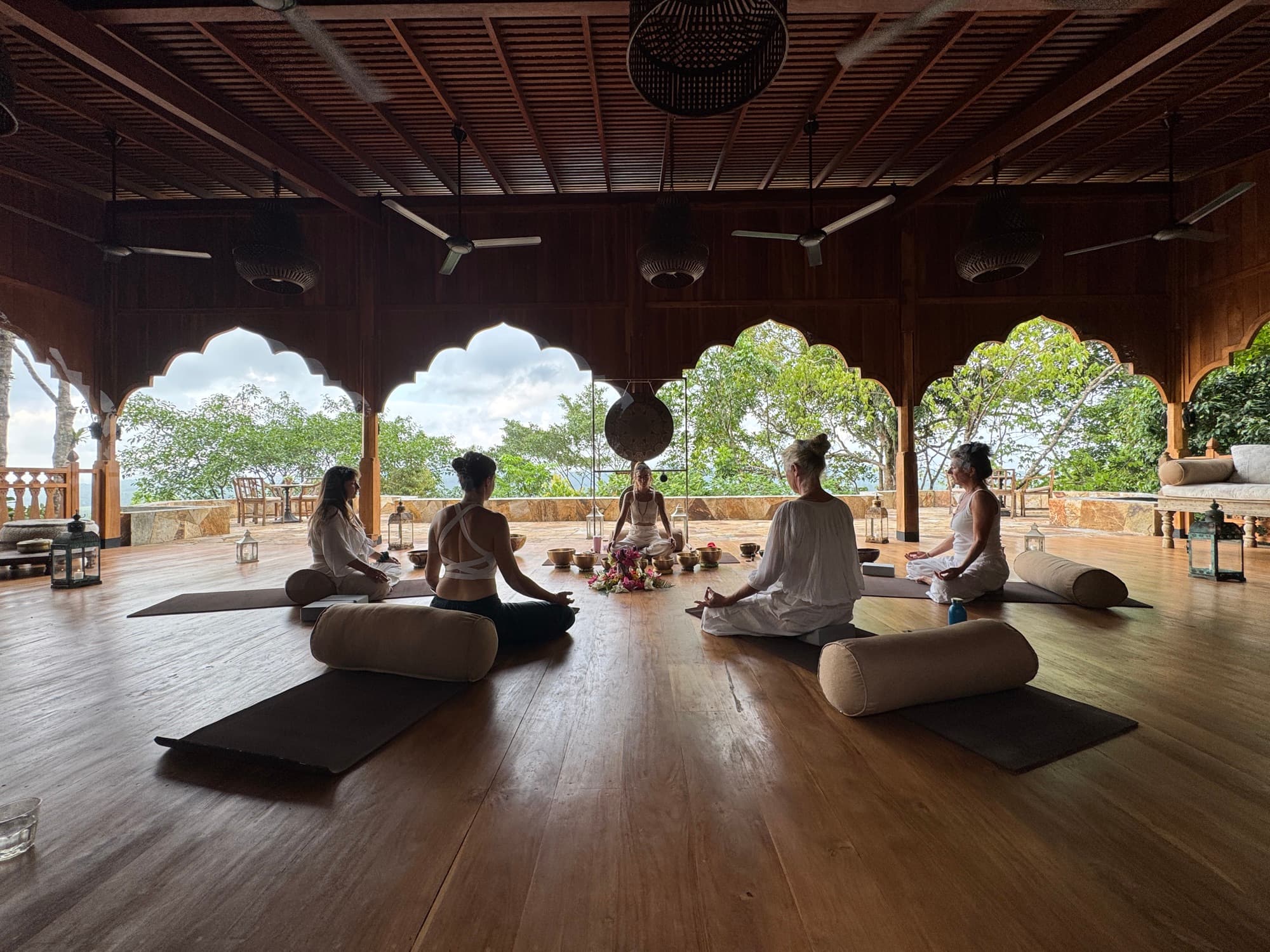 A yoga session in the open teak pavilion