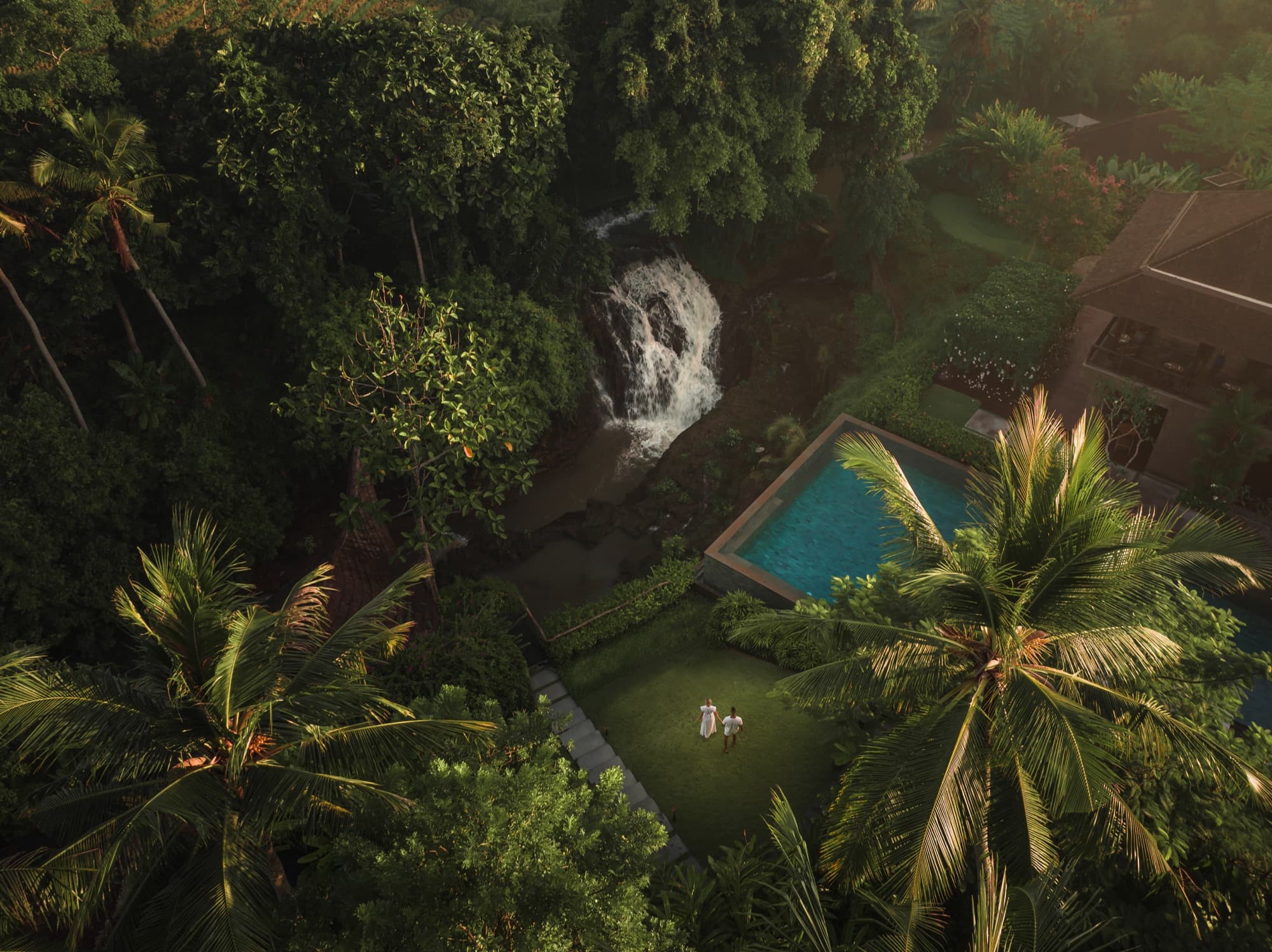 Aerial of the waterfall beside a private pool and lawn