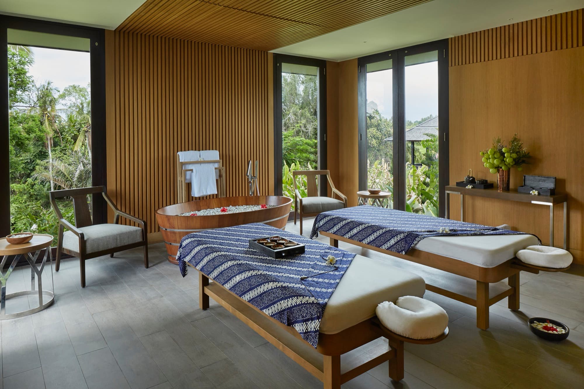 Treatment room at The Retreat with twin beds, copper tub and jungle views