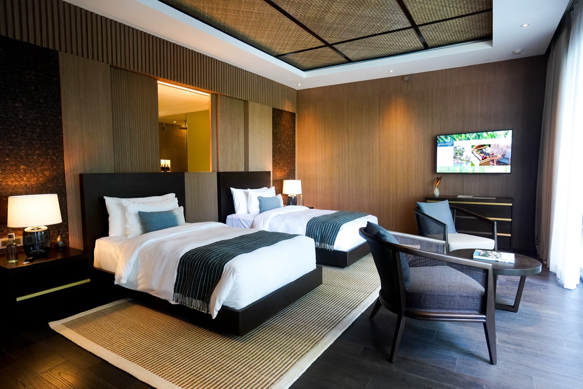 Twin bedroom at The Residence in warm timber