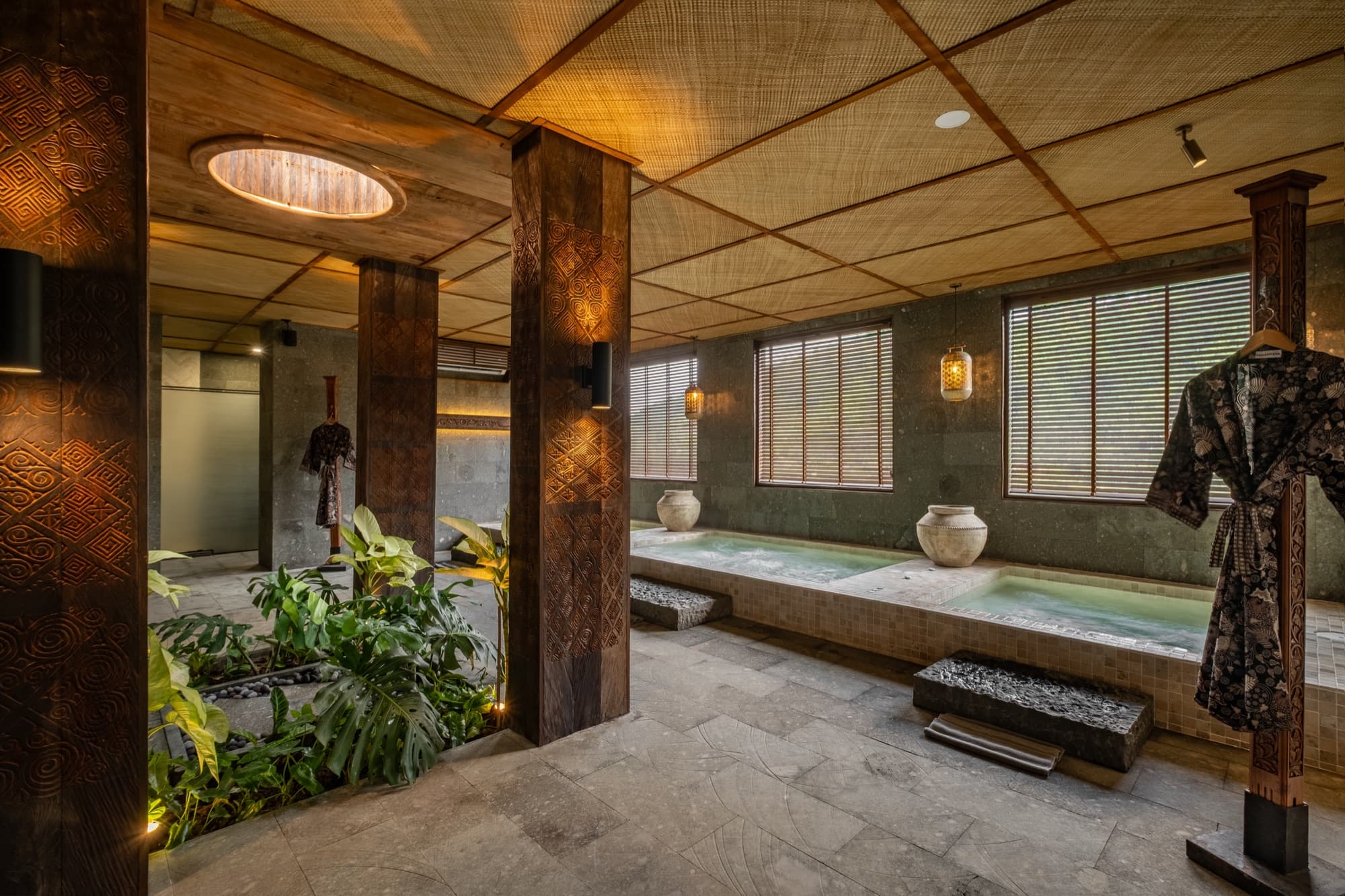 Ananda Bath House hammam — carved wooden doors, stone walls, and soaking pool