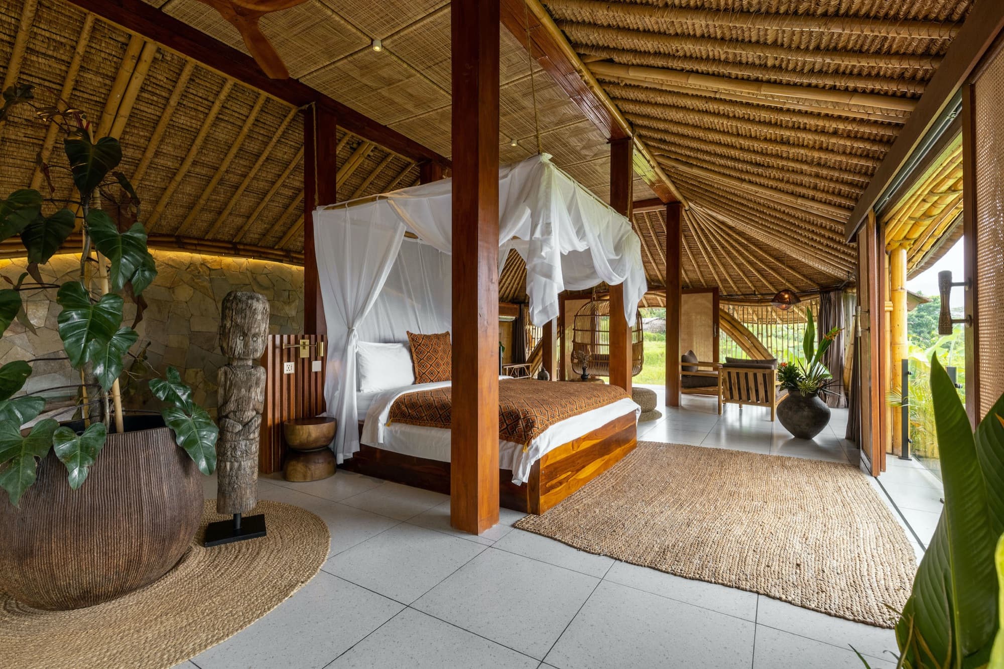 Rice Barn villa interior — reclaimed timber structure with traditional Balinese furnishings