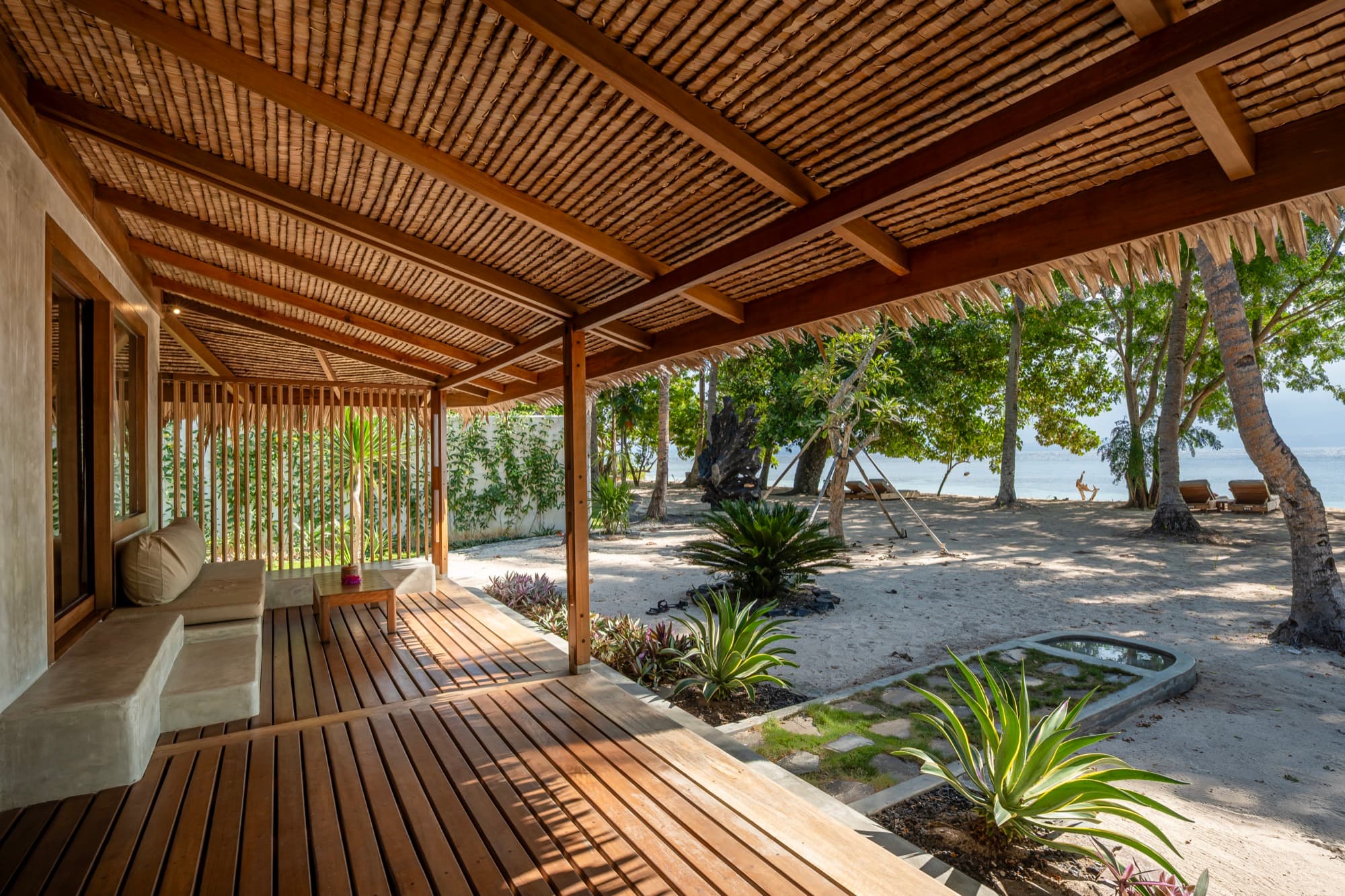 Beach View Villa terrace framed by a bamboo ceiling, facing the beach at Coral Eye