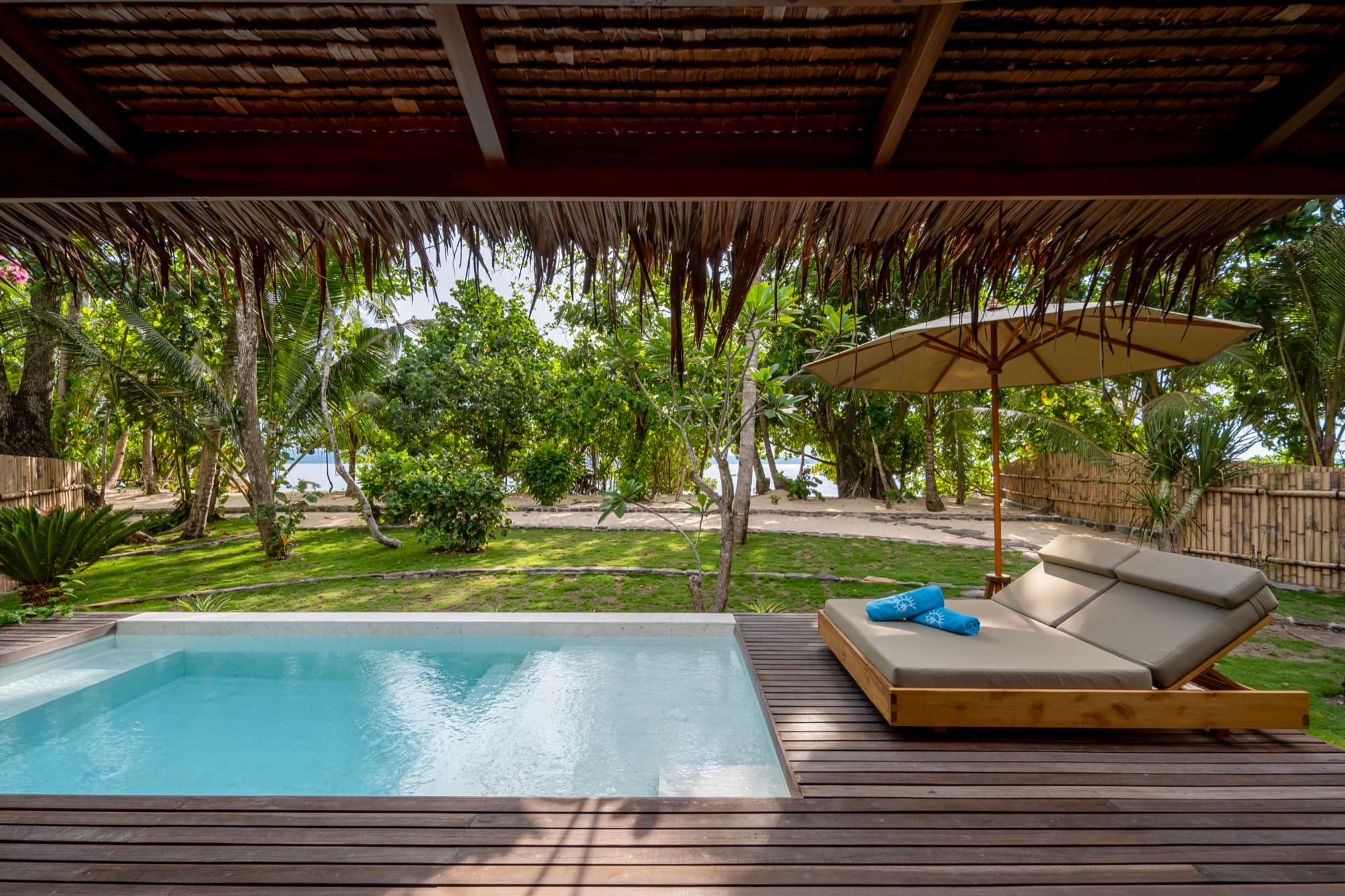 Beachfront Pool Villa interior opening onto the deck at Coral Eye