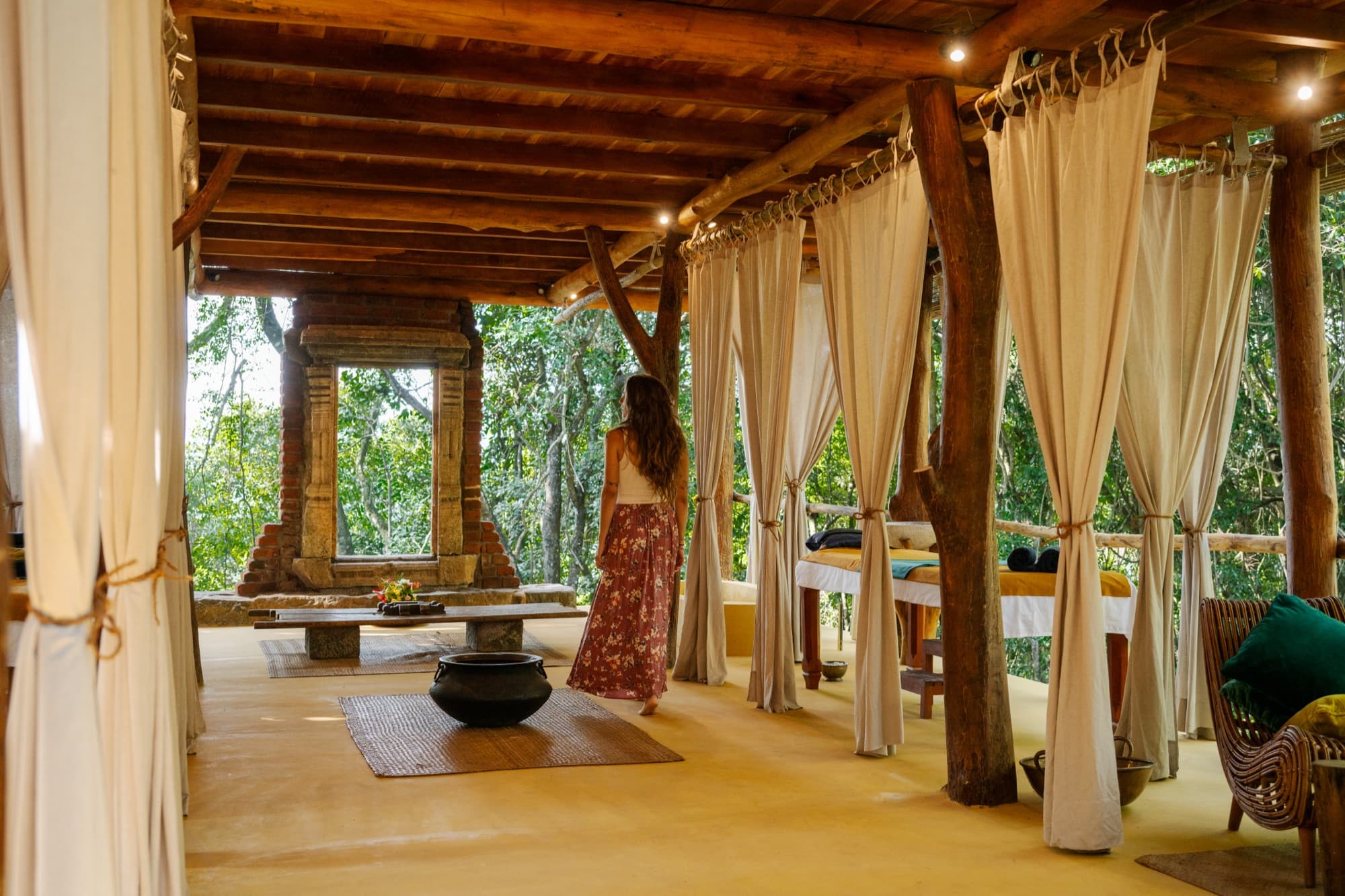 Ayurveda Pavilion treatment room open to the forest with curtained massage beds