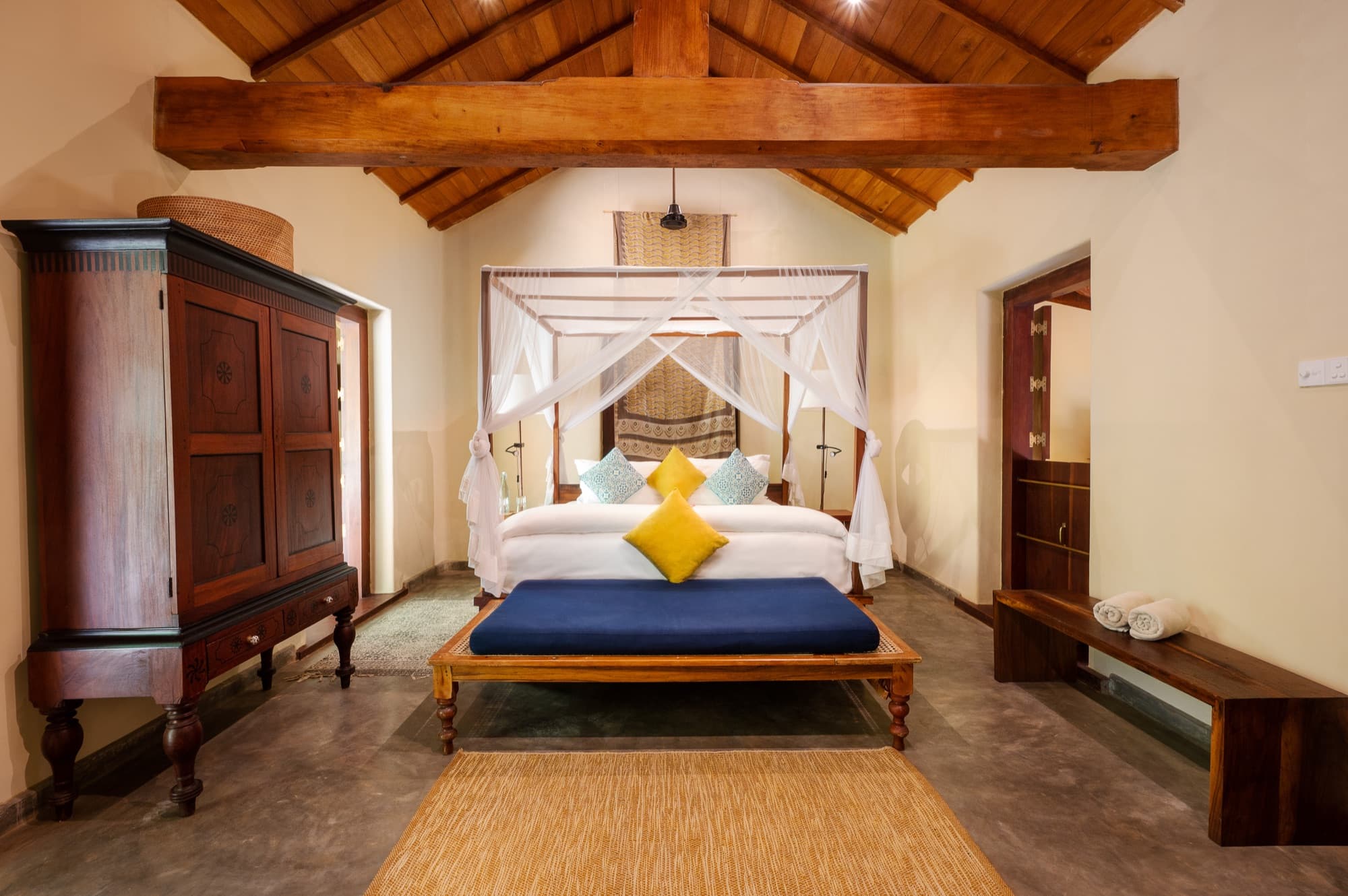 Villa Suite bedroom with a four-poster bed under a timber-beamed ceiling