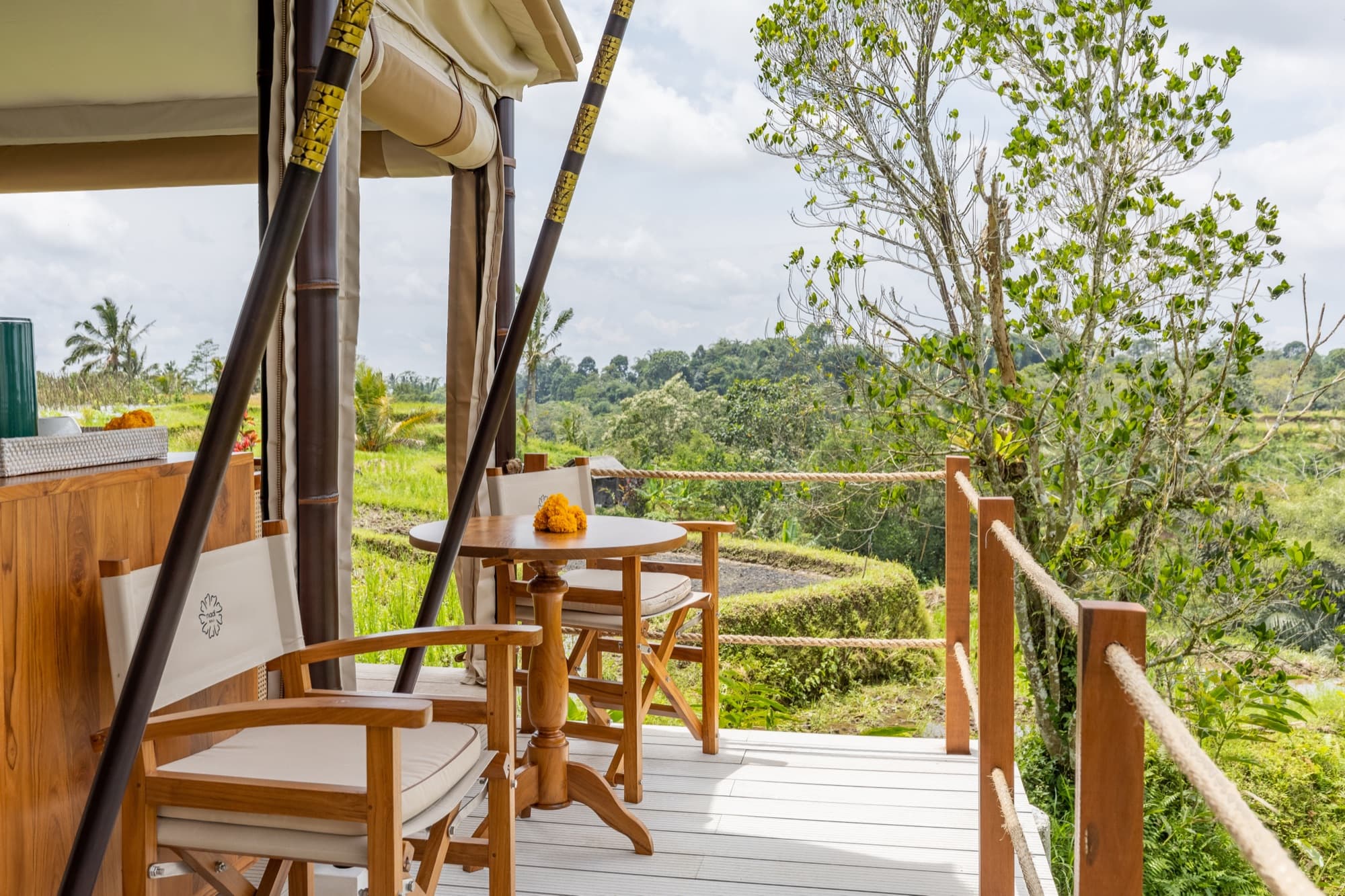 Breeze Tent private terrace with timber chairs overlooking the rice fields