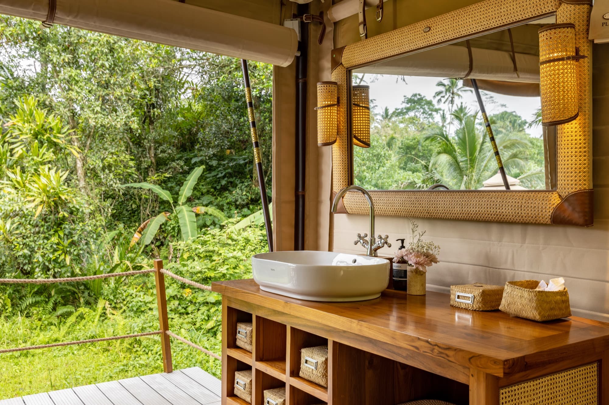 Waterfall Tent open-air vanity with timber console facing the tropical garden