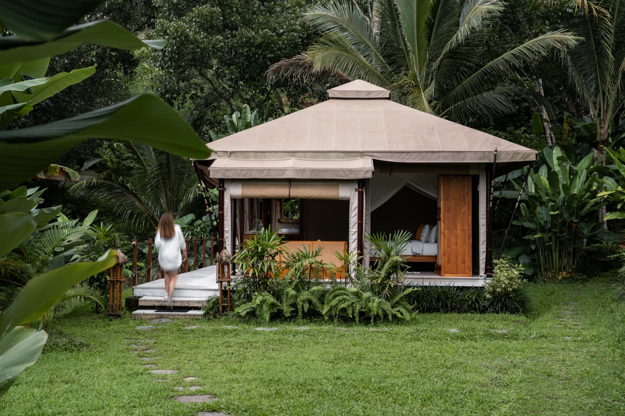 Pathway through tropical gardens leading to the Waterfall Tent