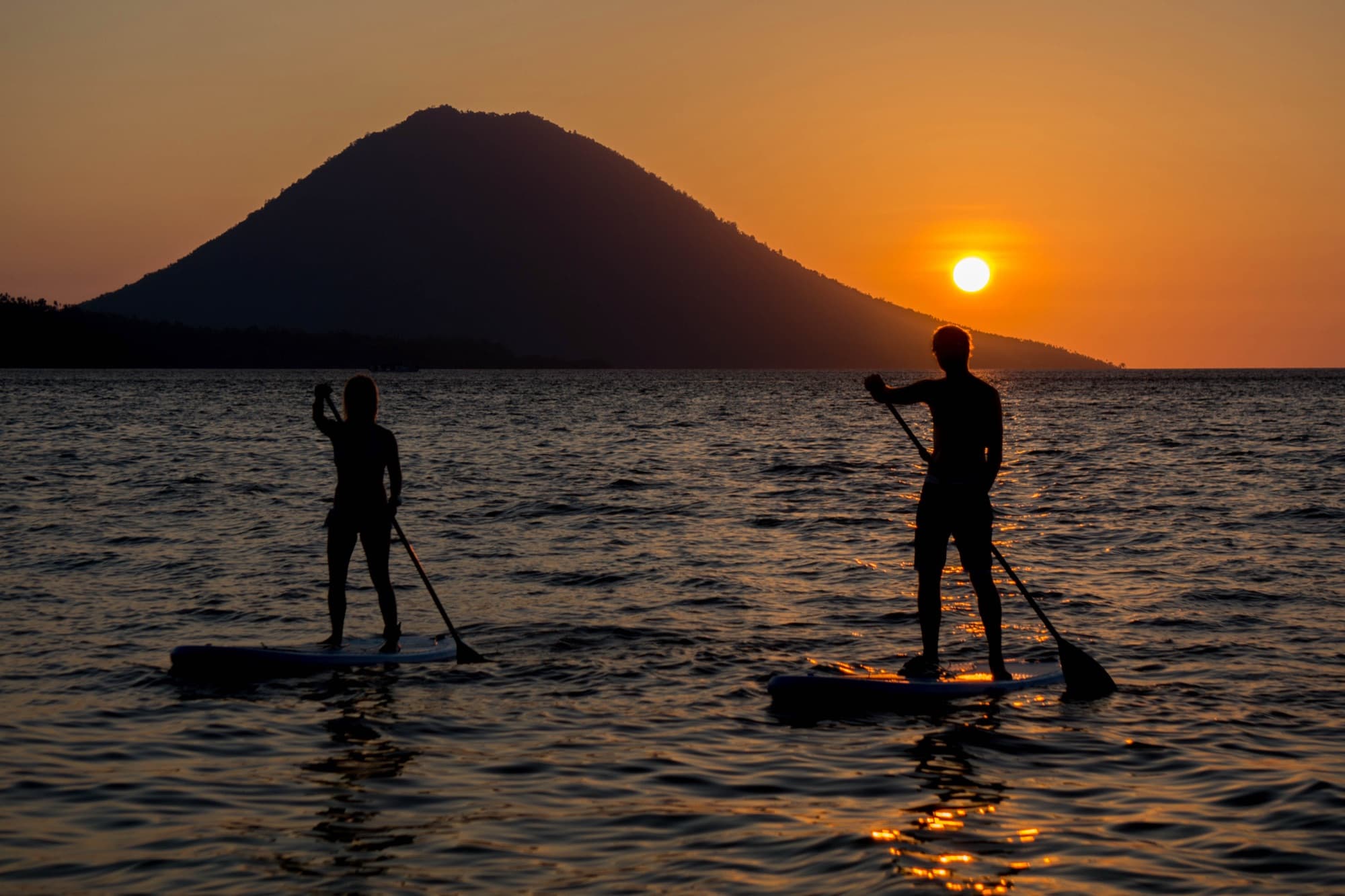 Kayaking and paddleboarding off the beach at Siladen