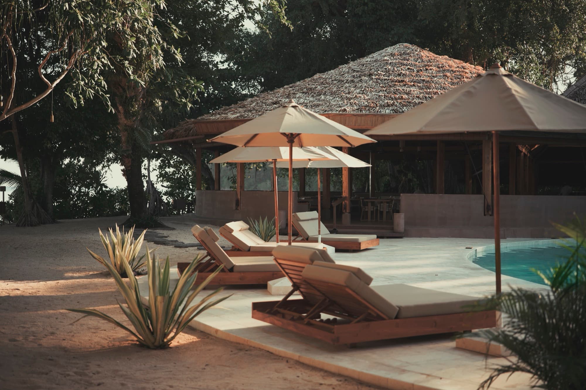 The saltwater pool and thatched pavilions at Siladen Resort