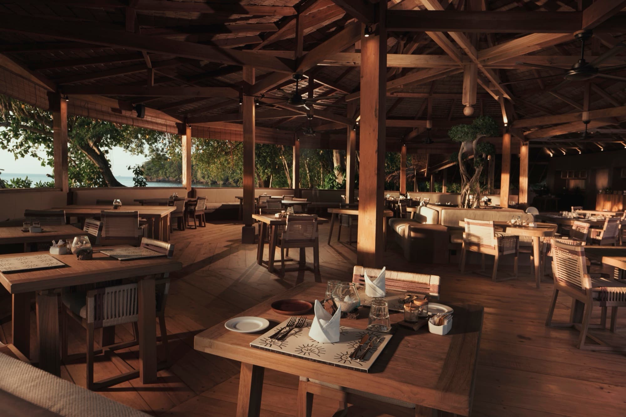 Beachside dining under the trees at Siladen Resort