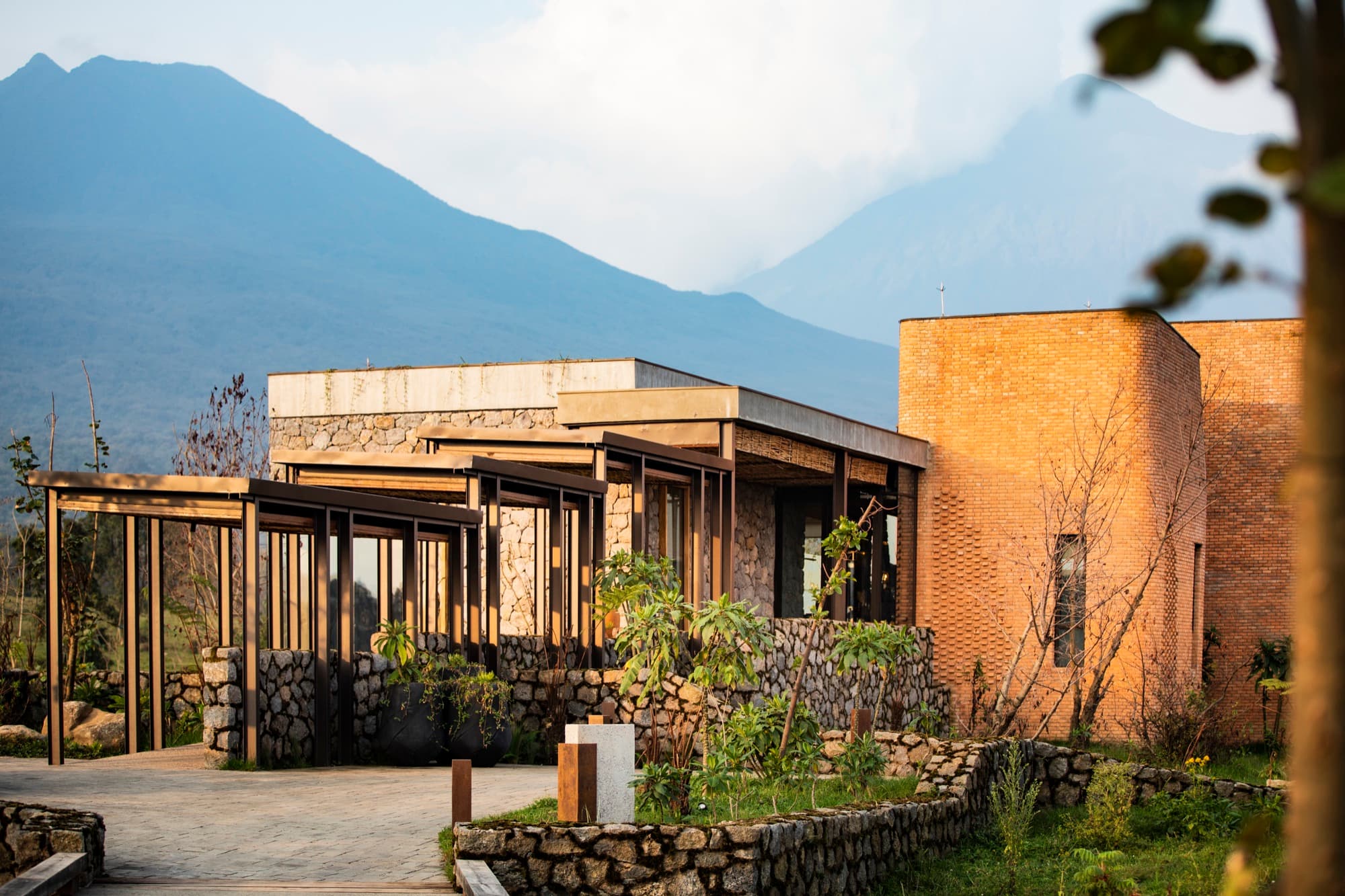 Stone and red brick buildings of the lodge below the volcanoes