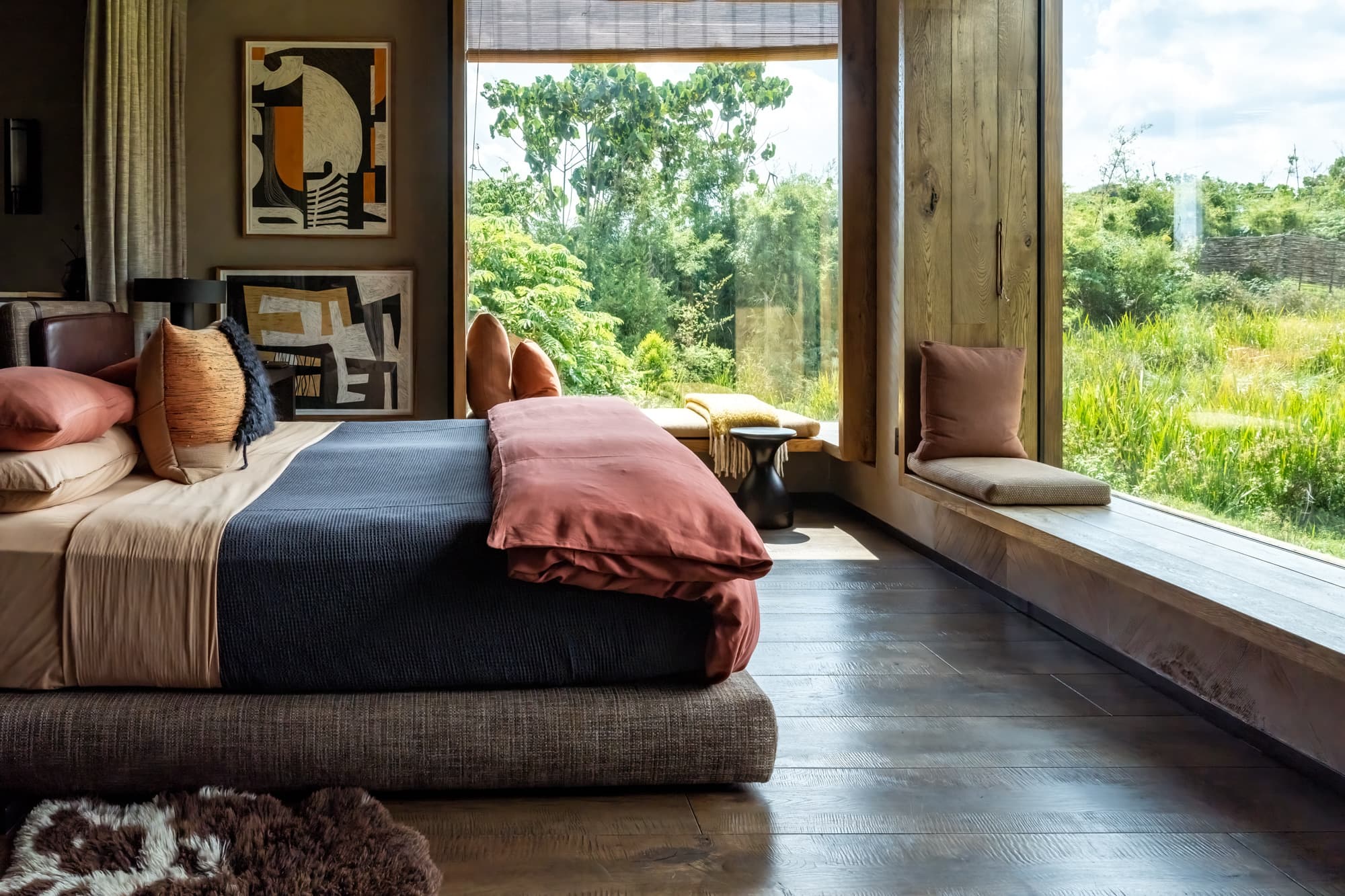 Suite bedroom with a window seat facing green fields