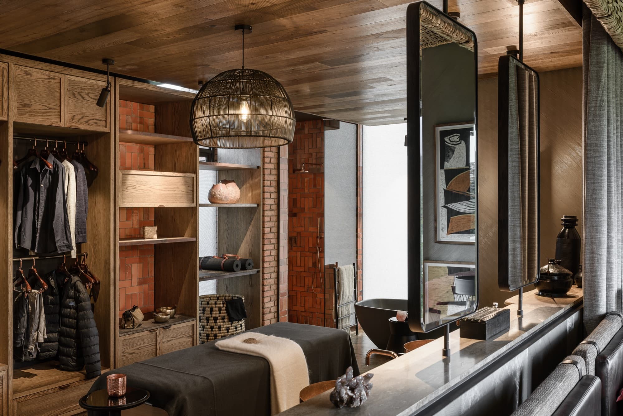 Dressing area with open wardrobe, mirror and massage table