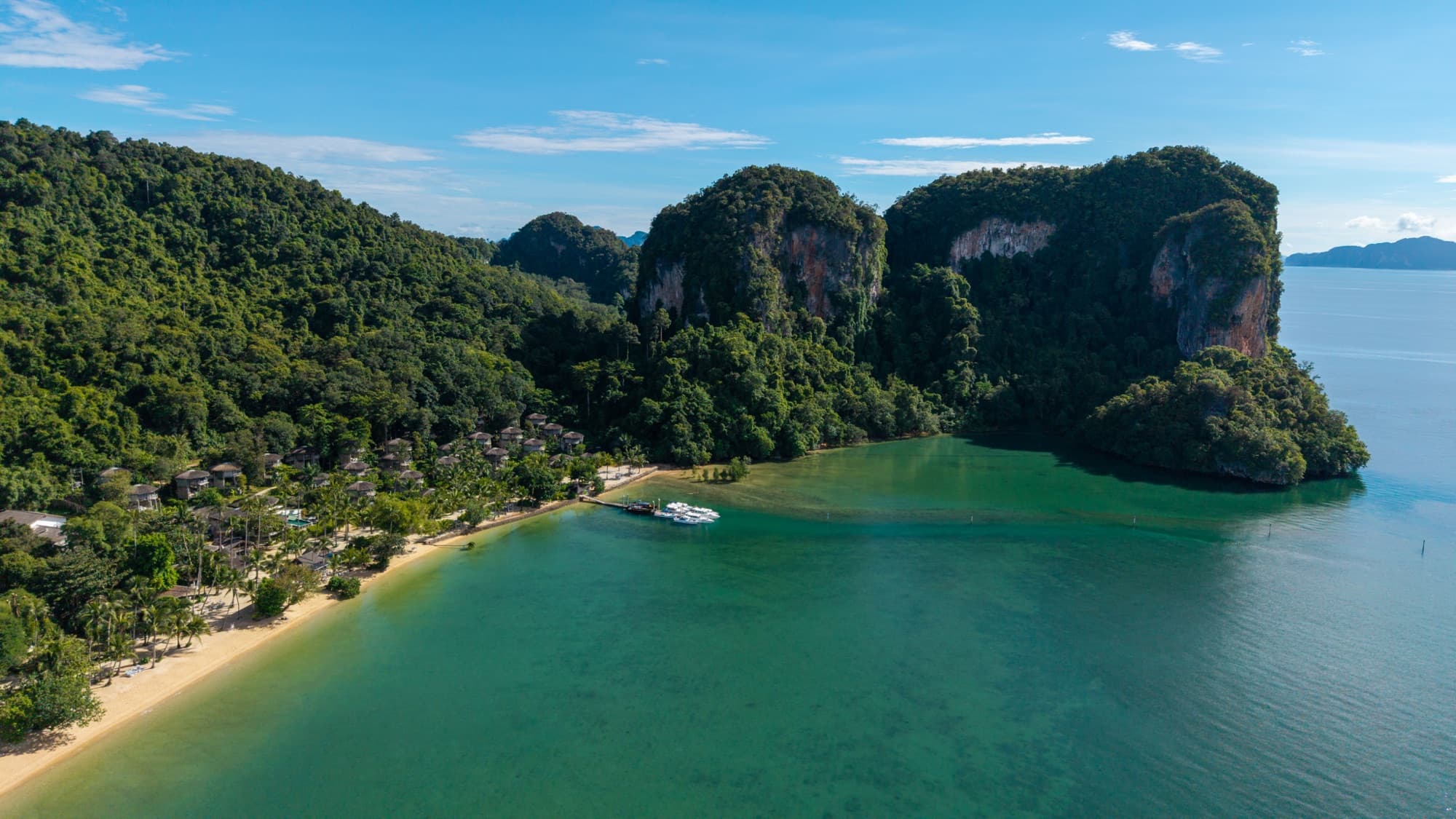 Aerial view of the bay, its limestone karsts and the resort beach on the shore of Koh Yao Noi