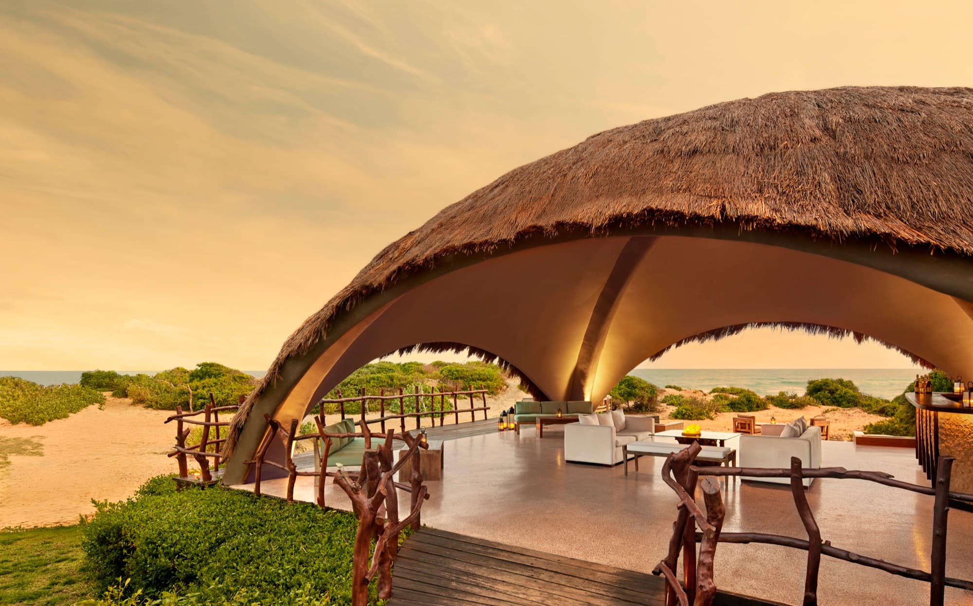The bar's thatched dome, open to the coast in the evening light