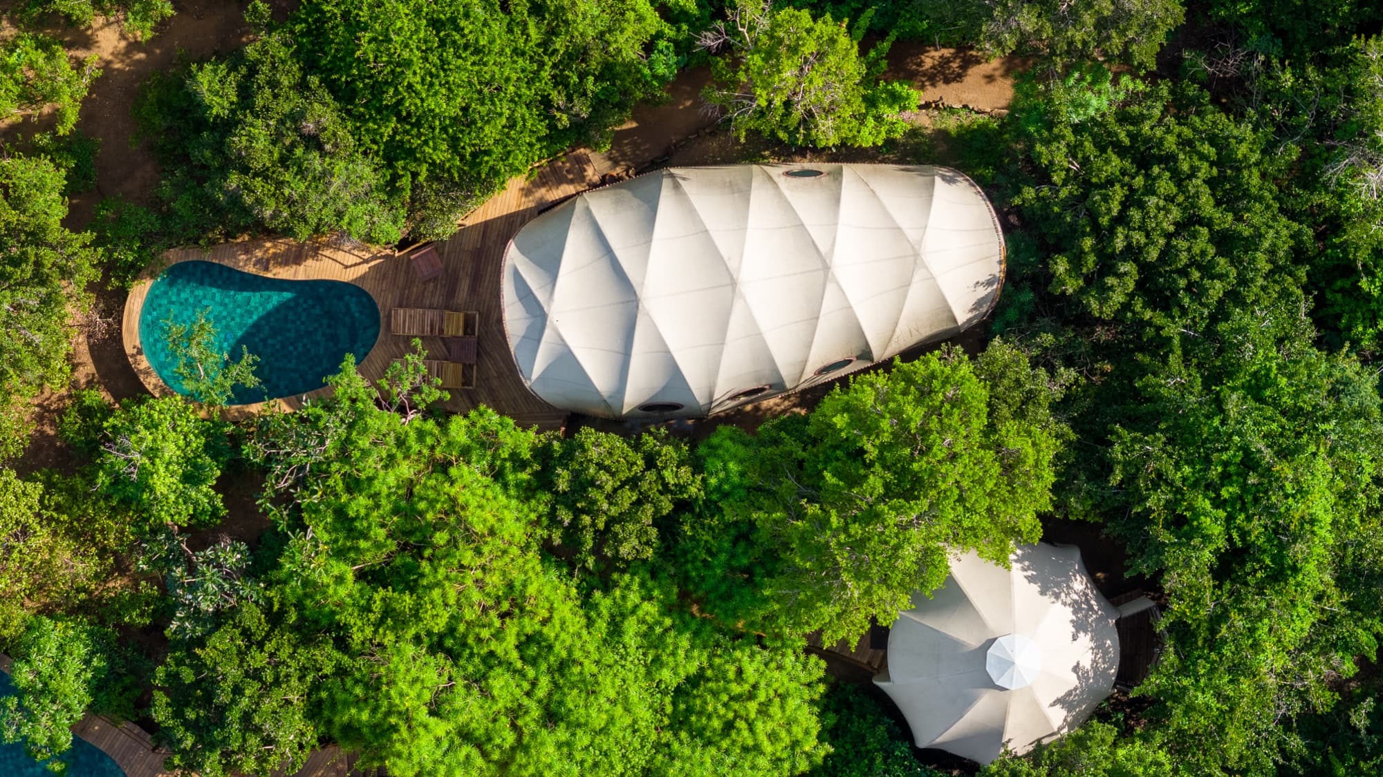 Aerial view of a Cocoon Pool Suite, its plunge pool and the path leading through the scrub