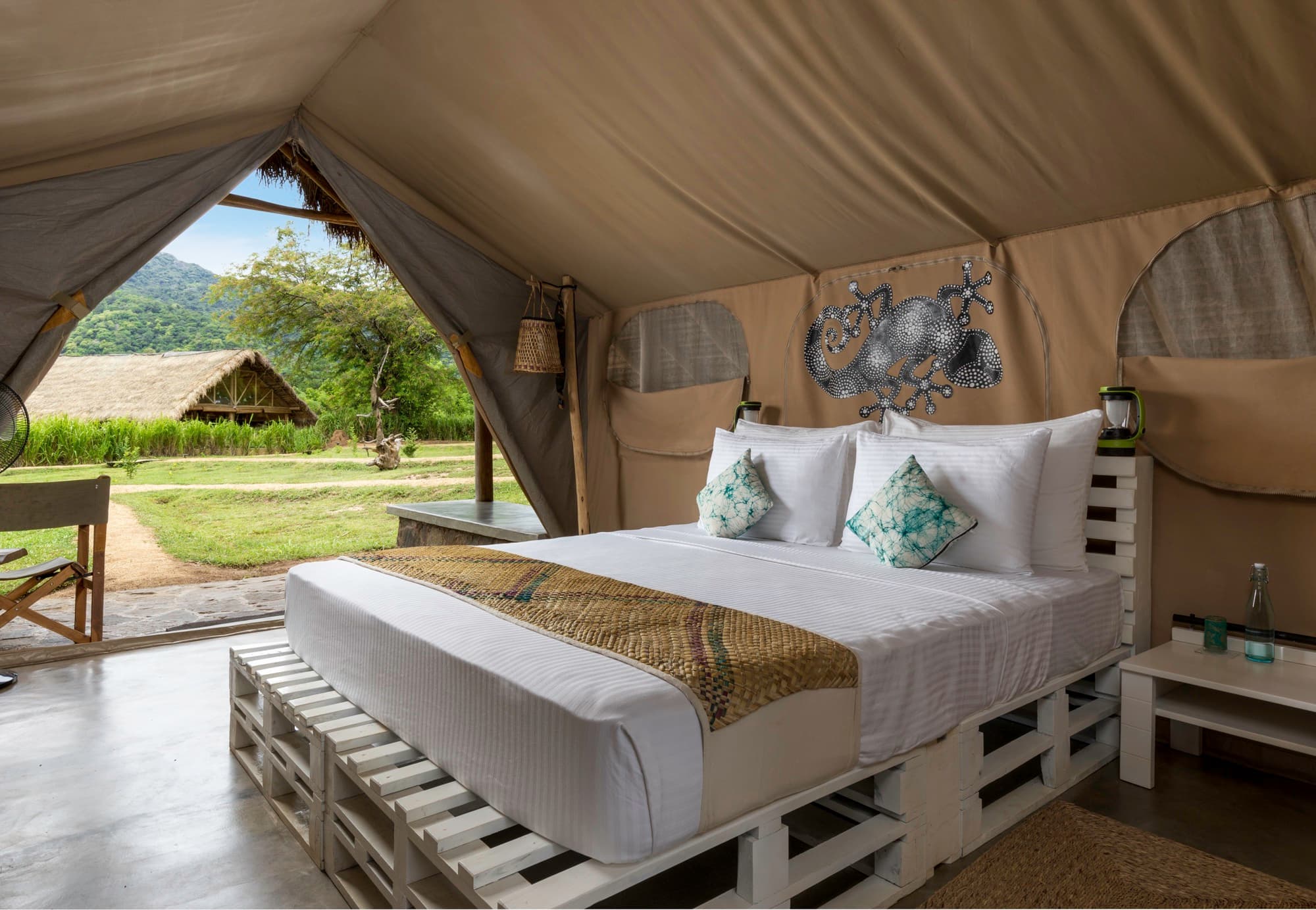 Deluxe Tent bedroom with king bed, opening onto the savannah and mountains