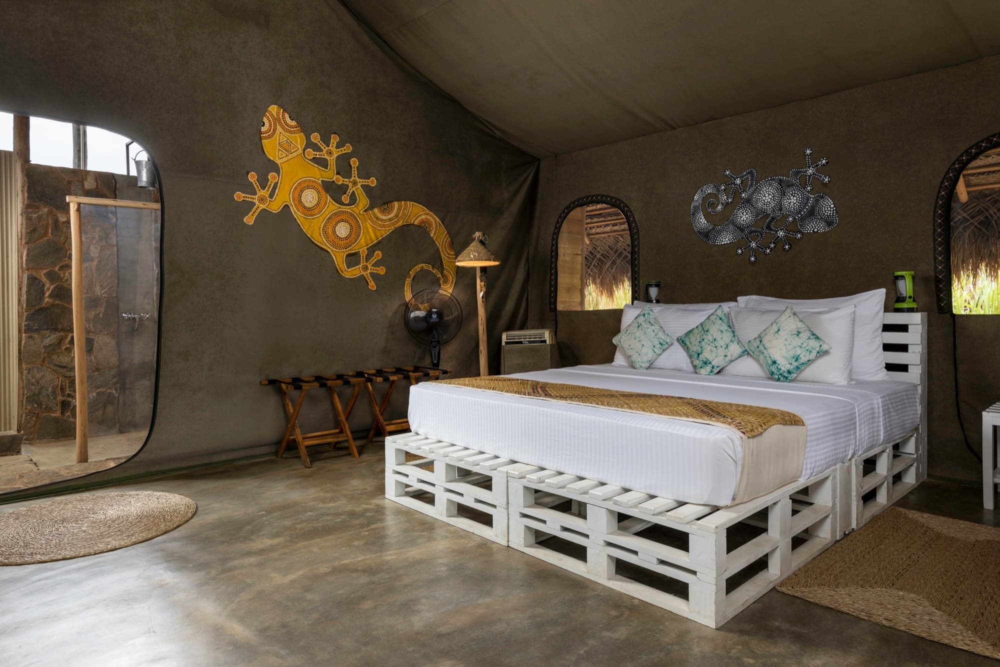 Family Tent bedroom with king bed and a Vedda-inspired gecko motif on the canvas wall