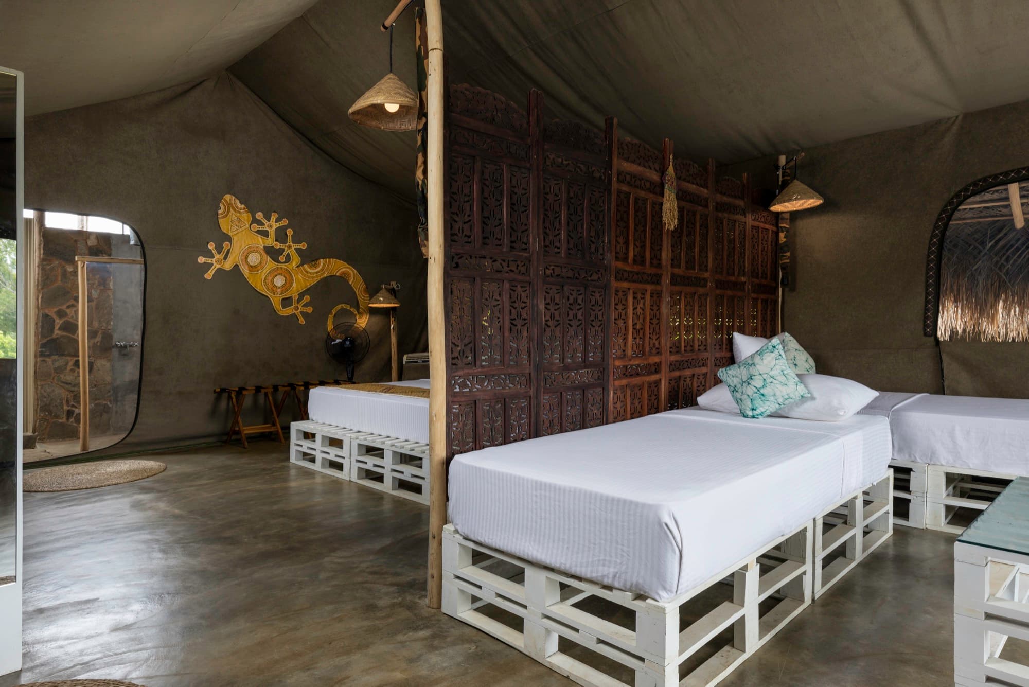 Family Tent twin beds separated from the main bedroom by a carved wooden divider