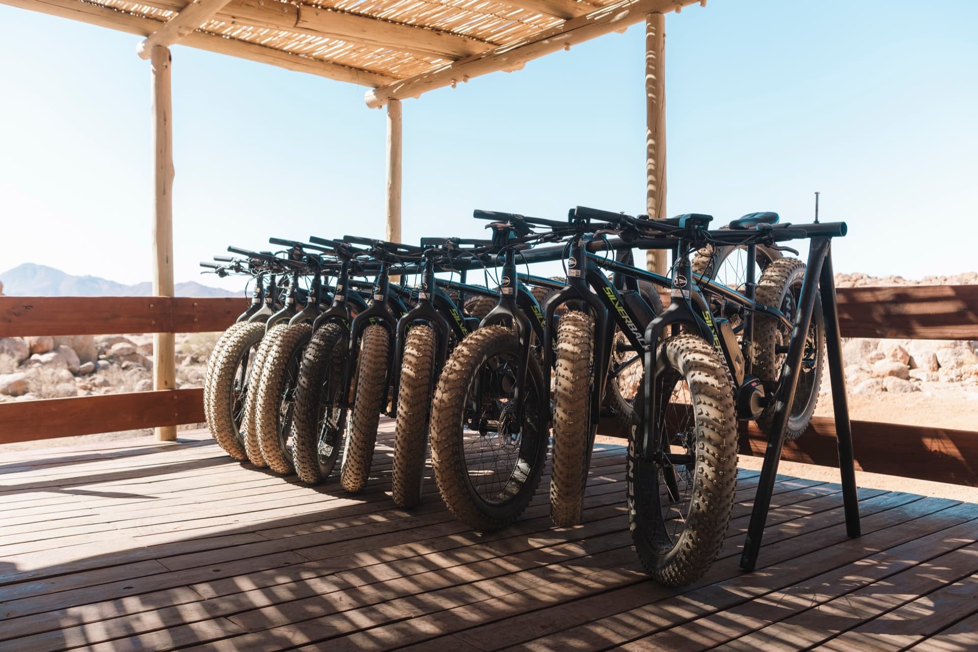 Electric fat bikes lined up under the bike shelter