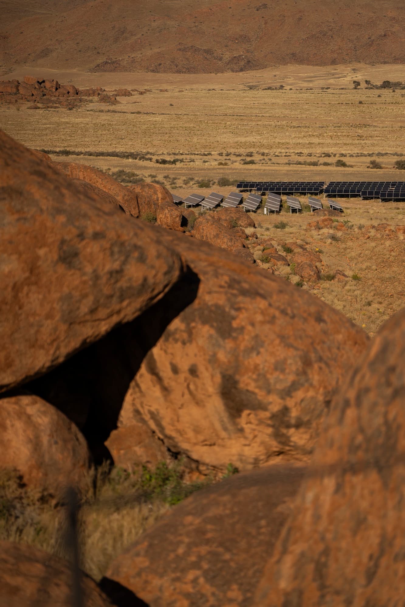 The lodge's granite boulders seen from above, the plains beyond