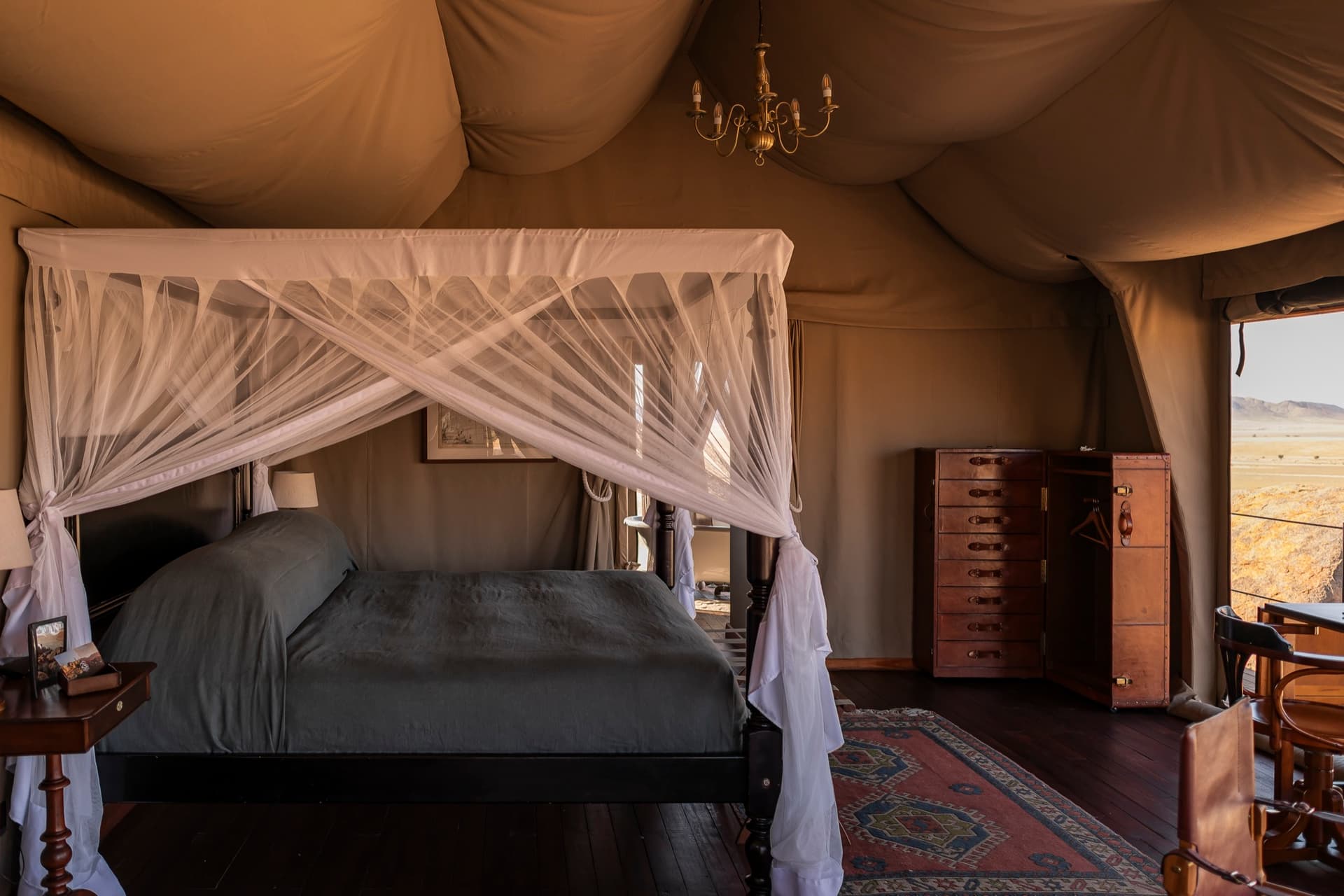 Bed with a mosquito net in a canvas tent