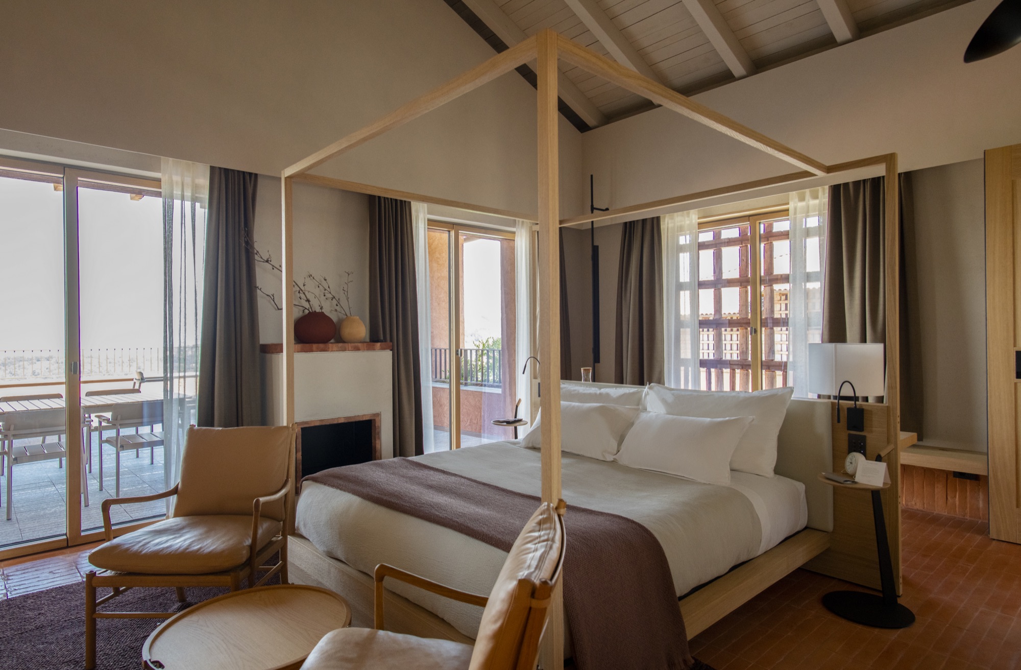 Monviso Suite with a wooden canopy bed