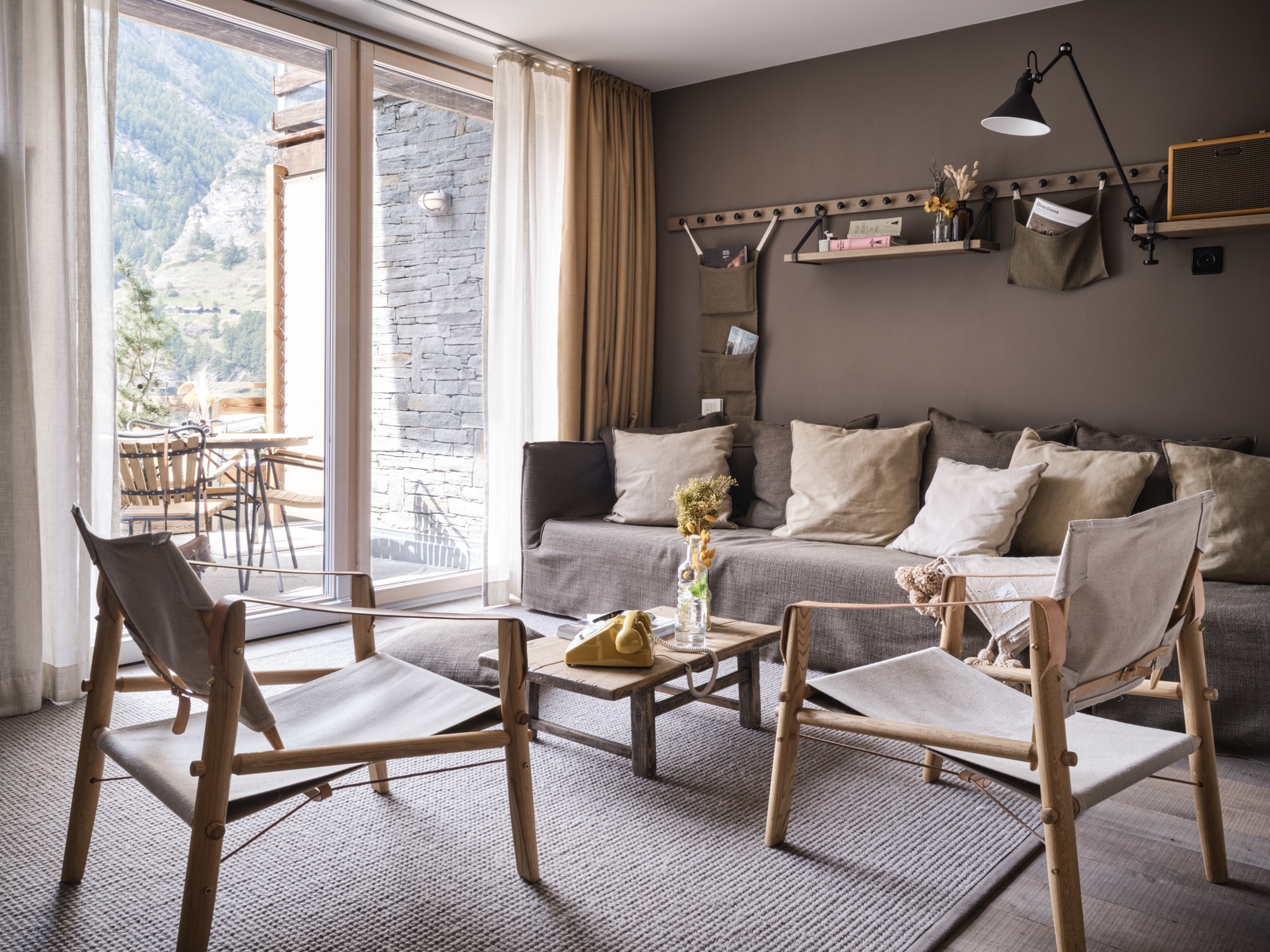 Seating area with a sofa and two armchairs by the balcony door