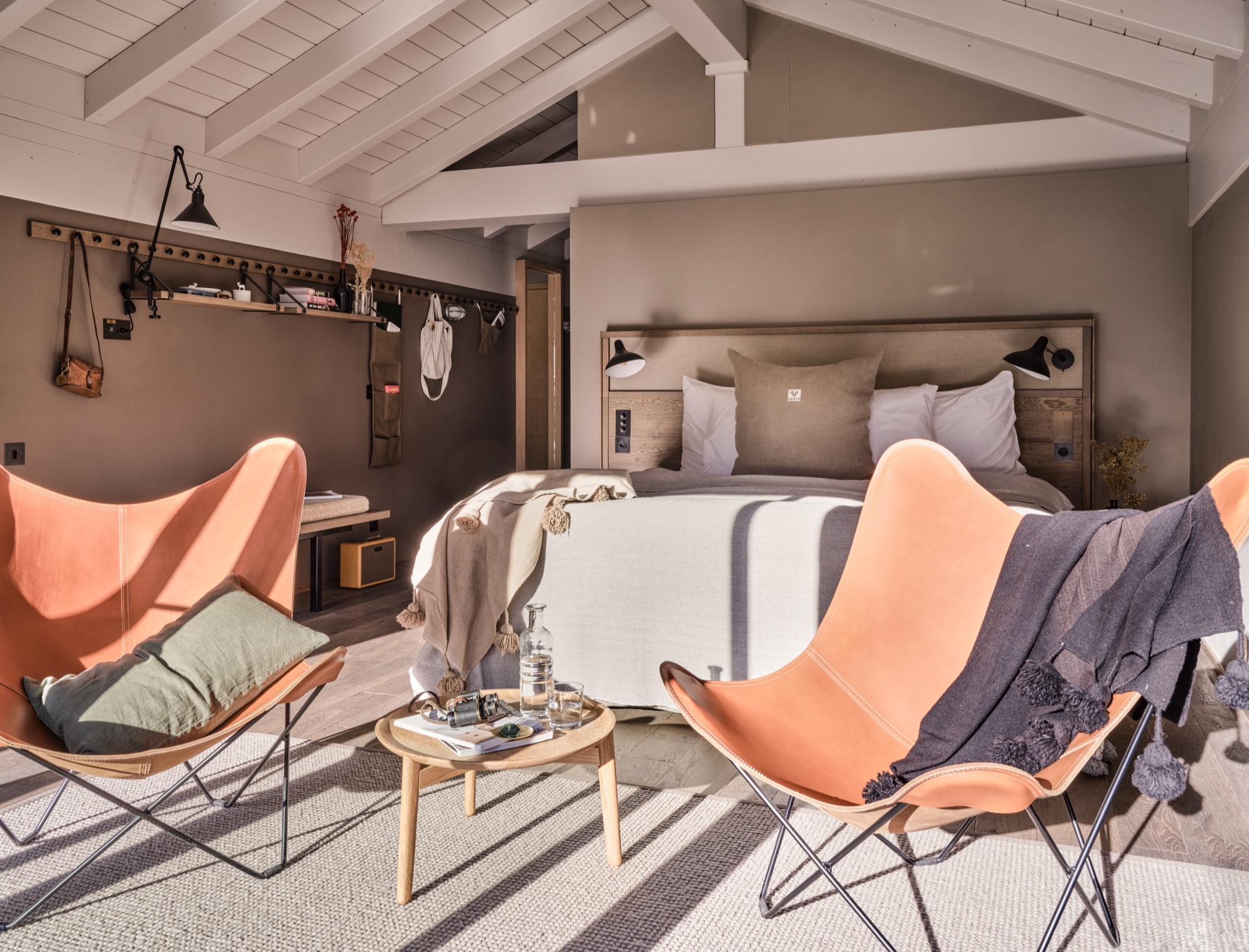 Bedroom under a sloping ceiling, with two butterfly chairs