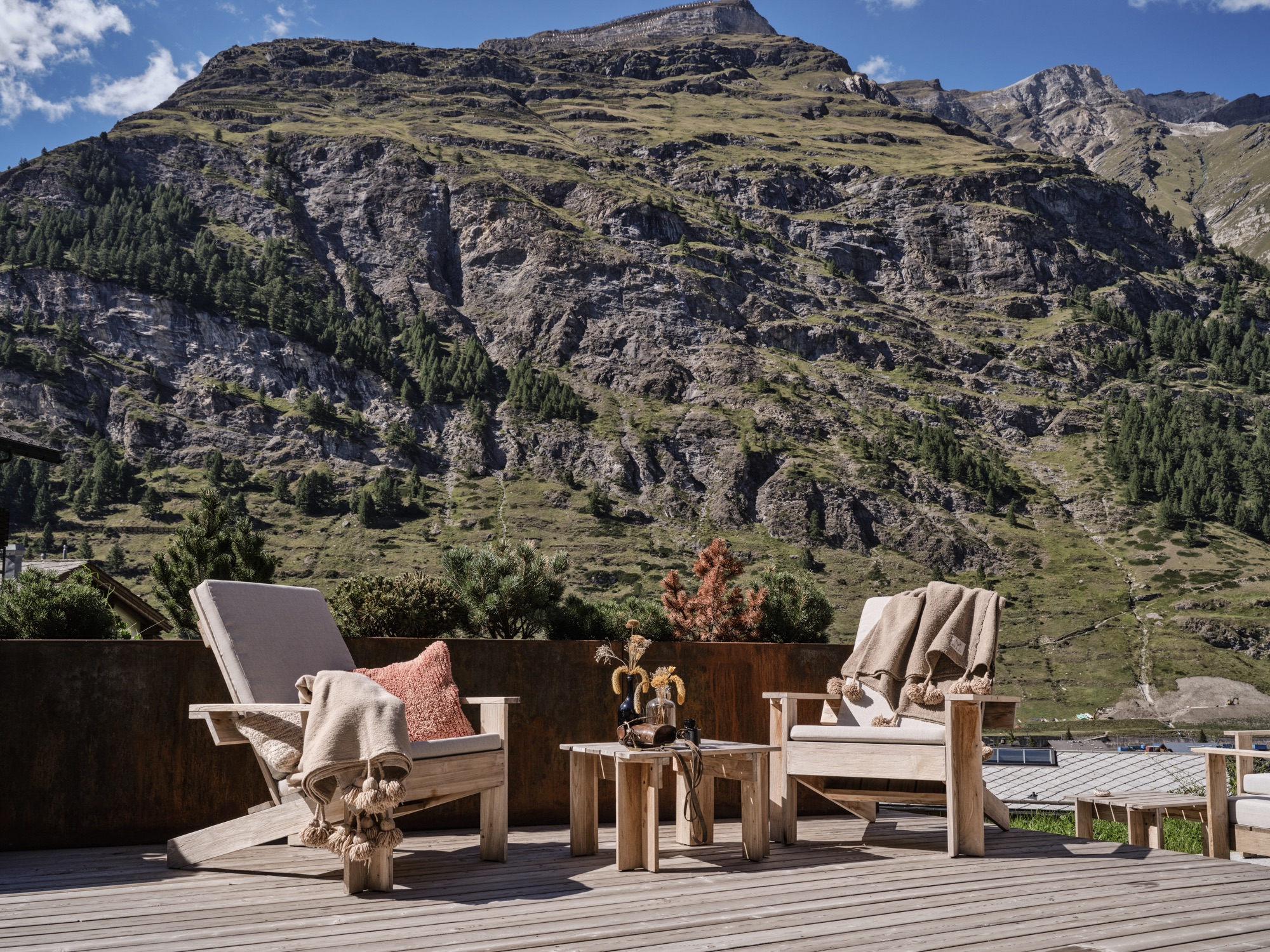 Wooden loungers on a sun terrace facing the mountainside