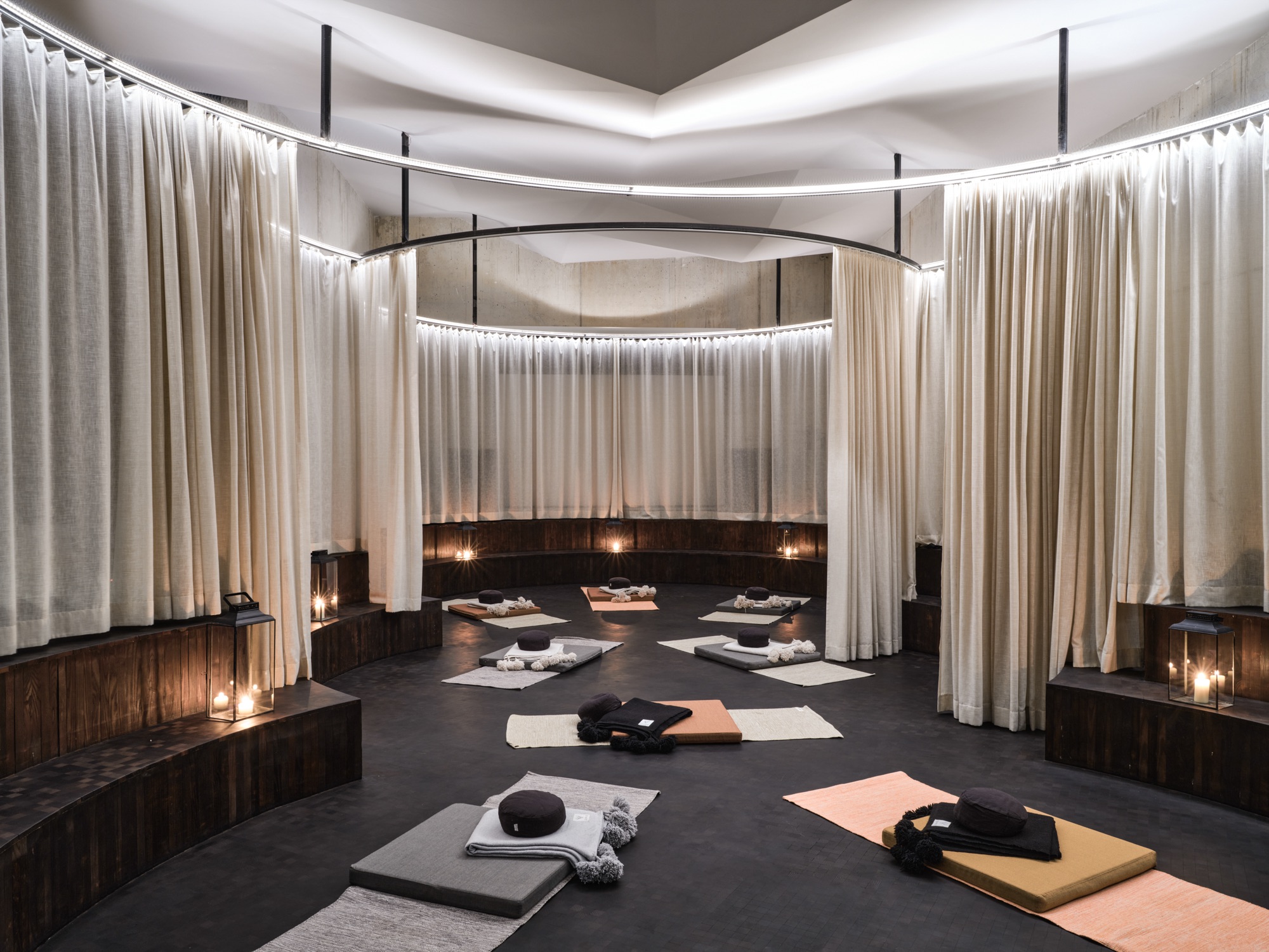 Ritual room with yoga mats inside a ring of curtains