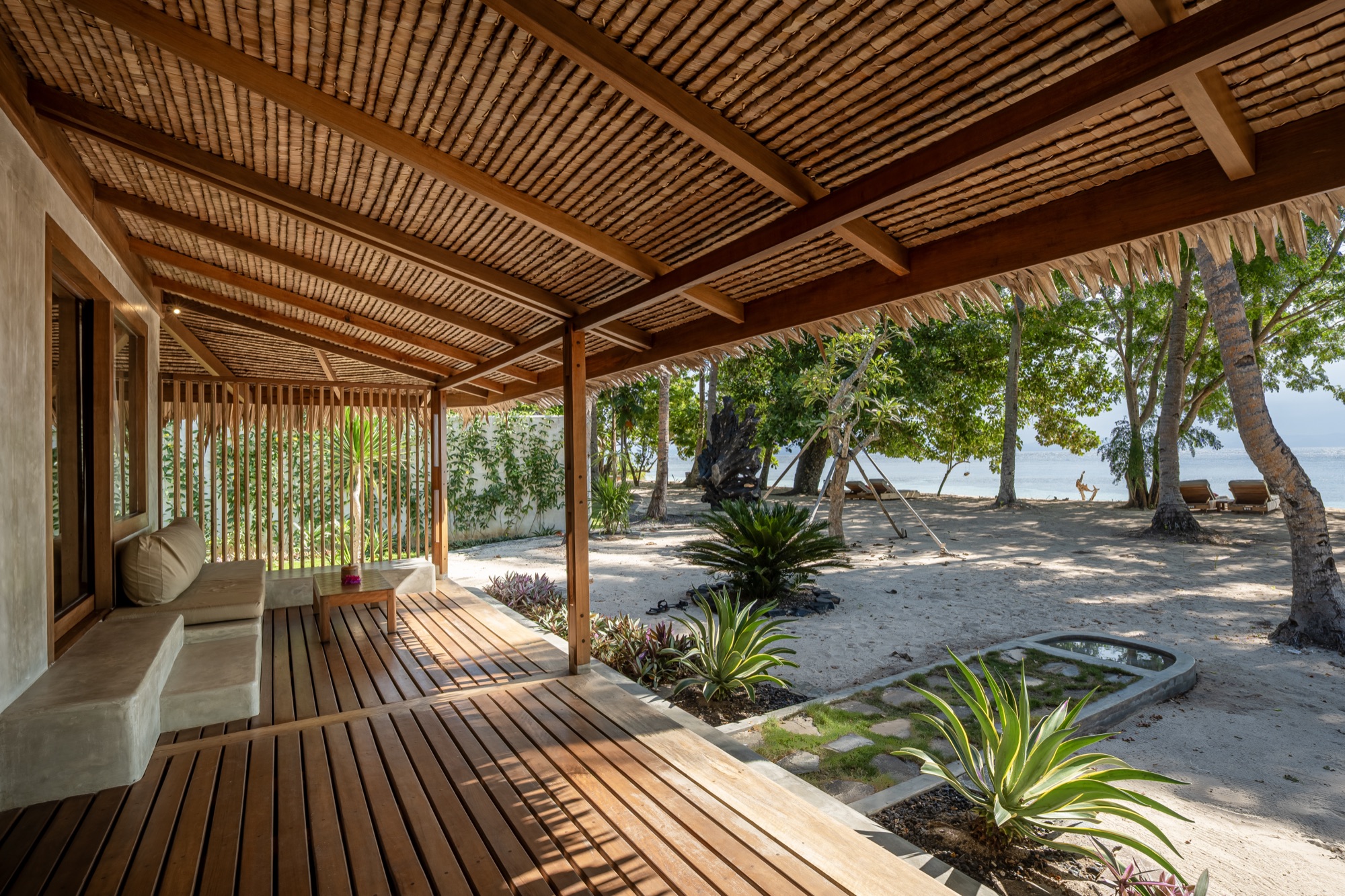 Beach View Villa terrace framed by a bamboo ceiling, facing the beach at Coral Eye