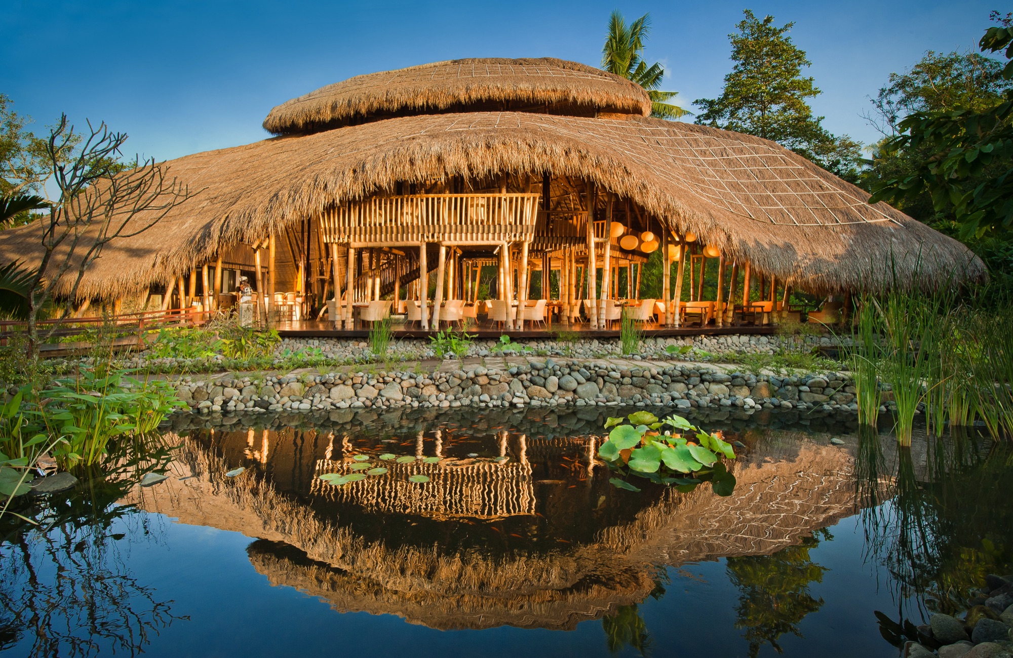 Sakti Dining Room bamboo structure reflected in the lotus pond