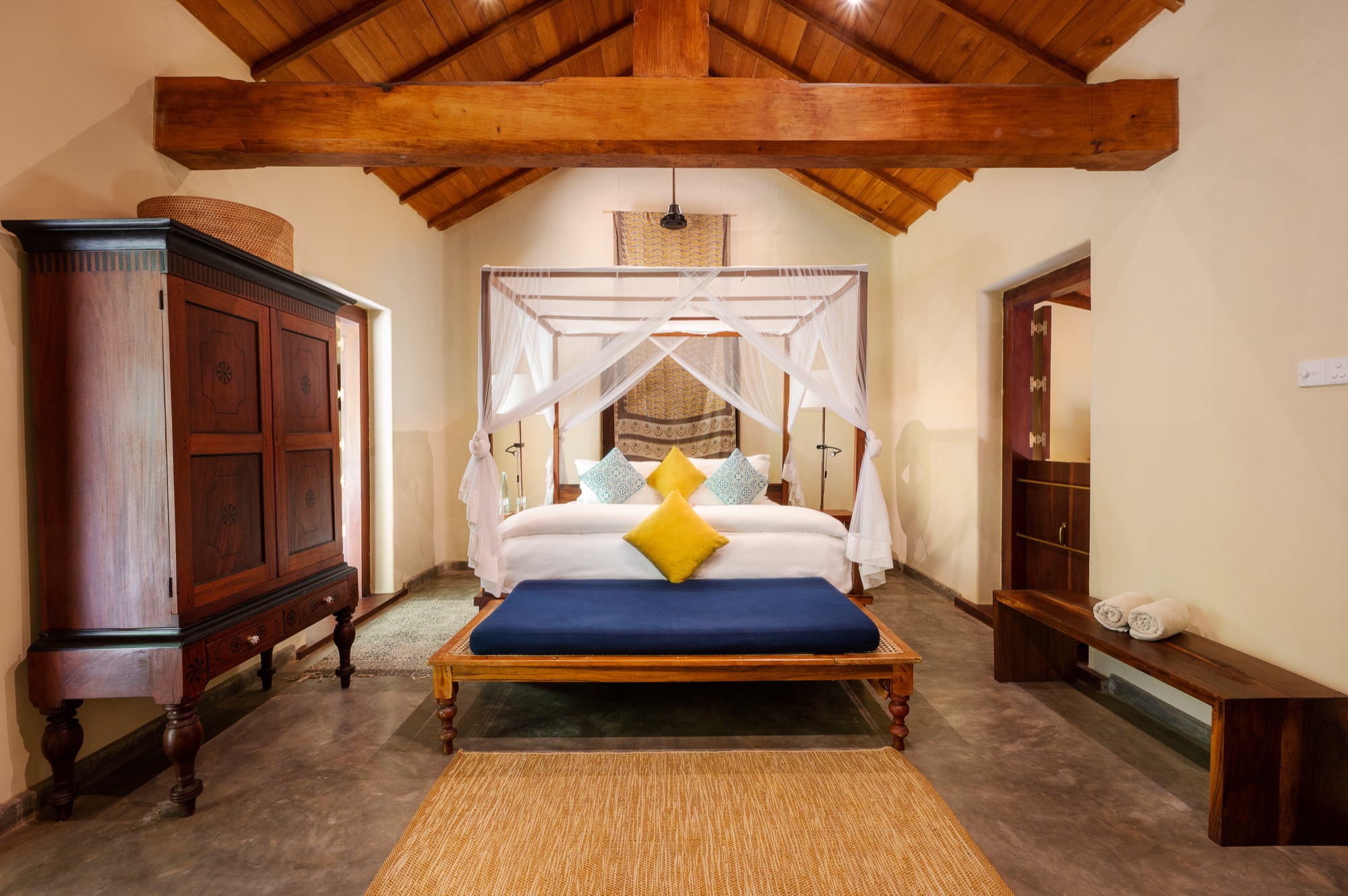 Villa Suite bedroom with a four-poster bed under a timber-beamed ceiling