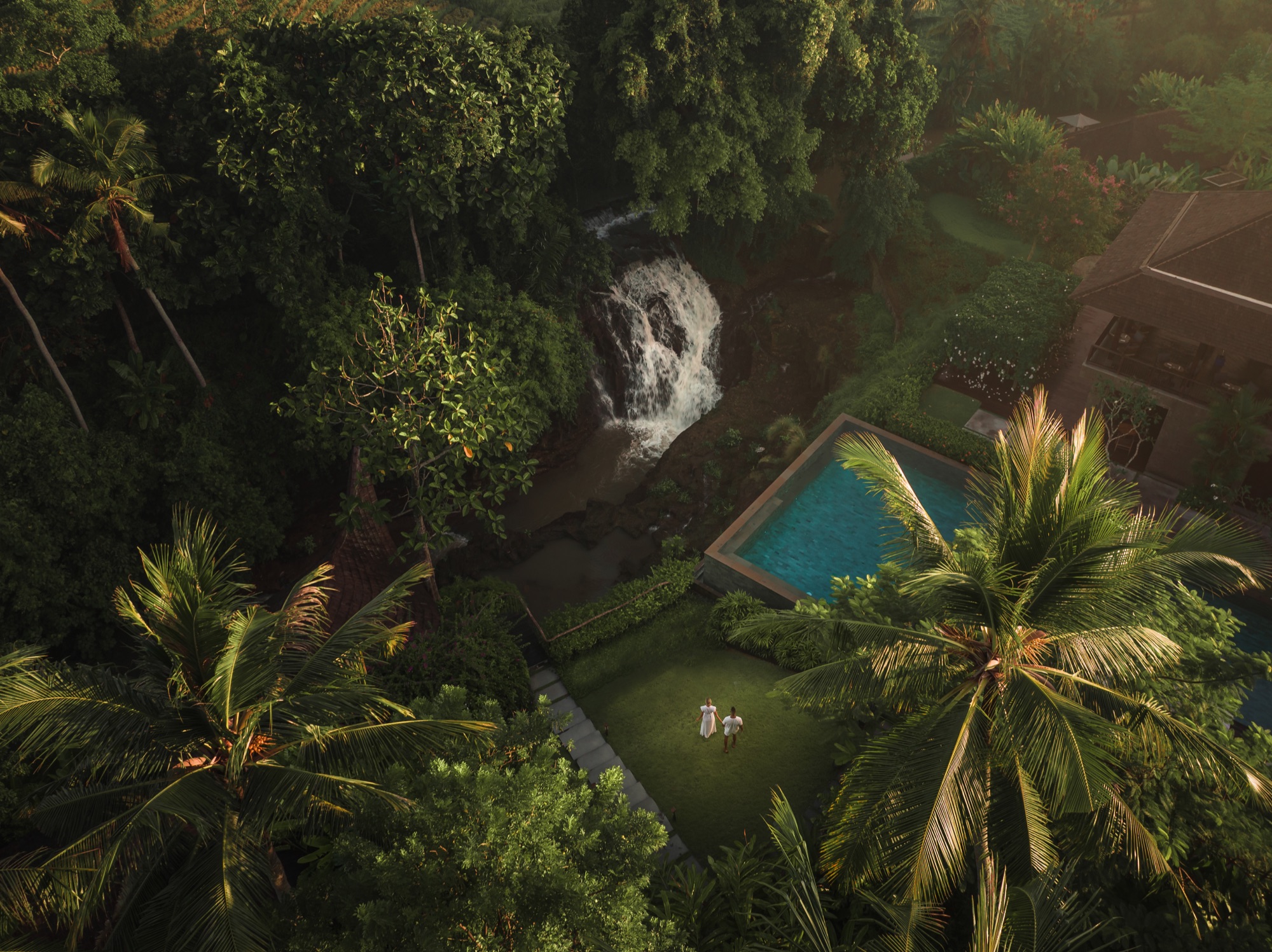 Aerial of the waterfall beside a private pool and lawn