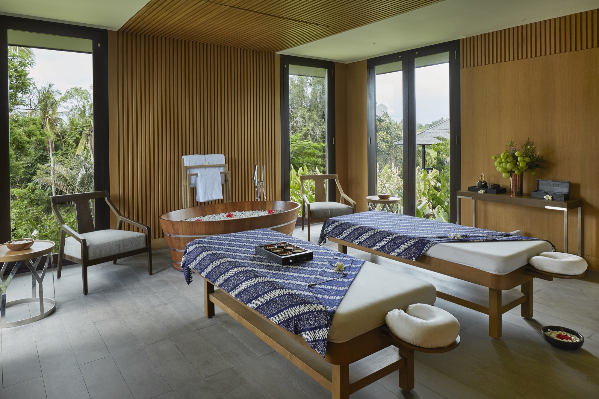 Treatment room at The Retreat with twin beds, copper tub and jungle views