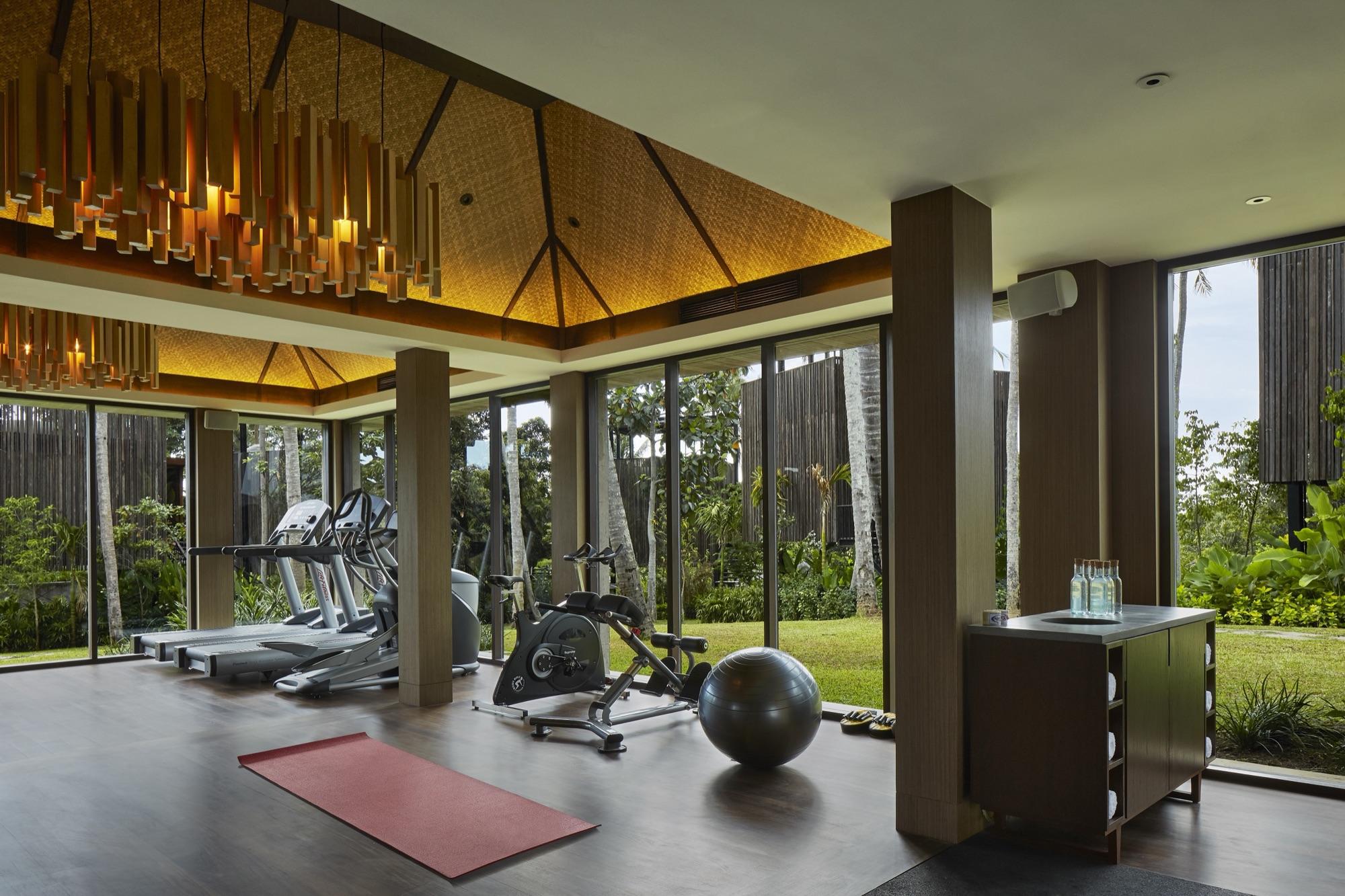 Fitness centre with floor-to-ceiling windows onto the garden