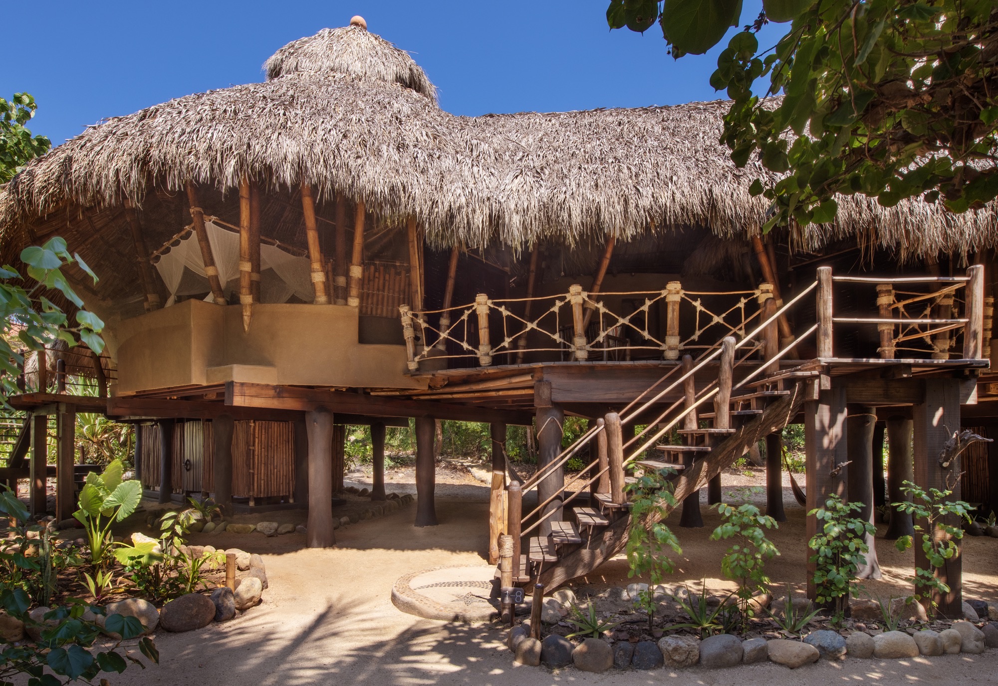 Thatched building on stilts that houses the Deluxe Suites and Studios