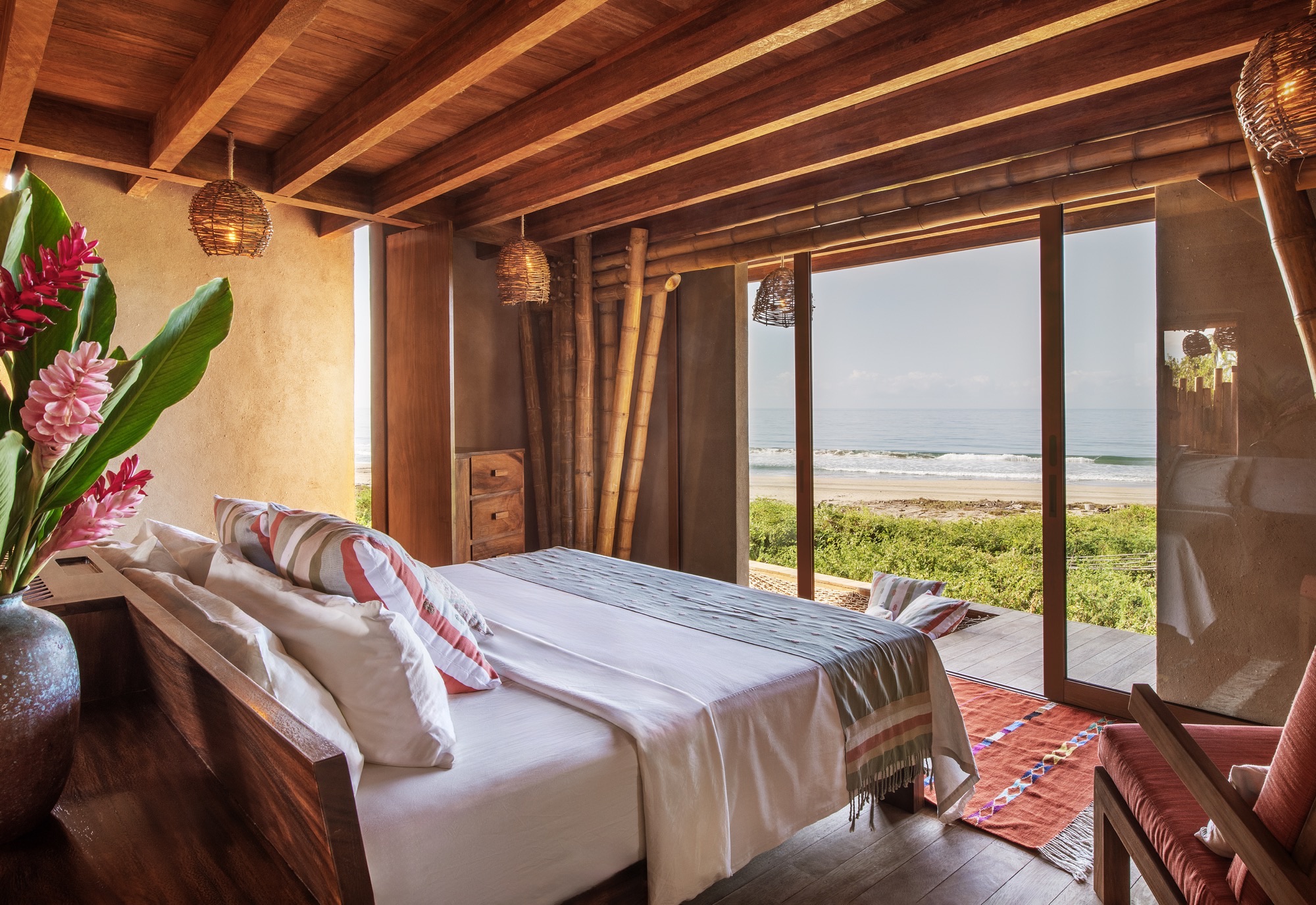Bedroom of the Infinity Casita with a window onto the dunes and the sea