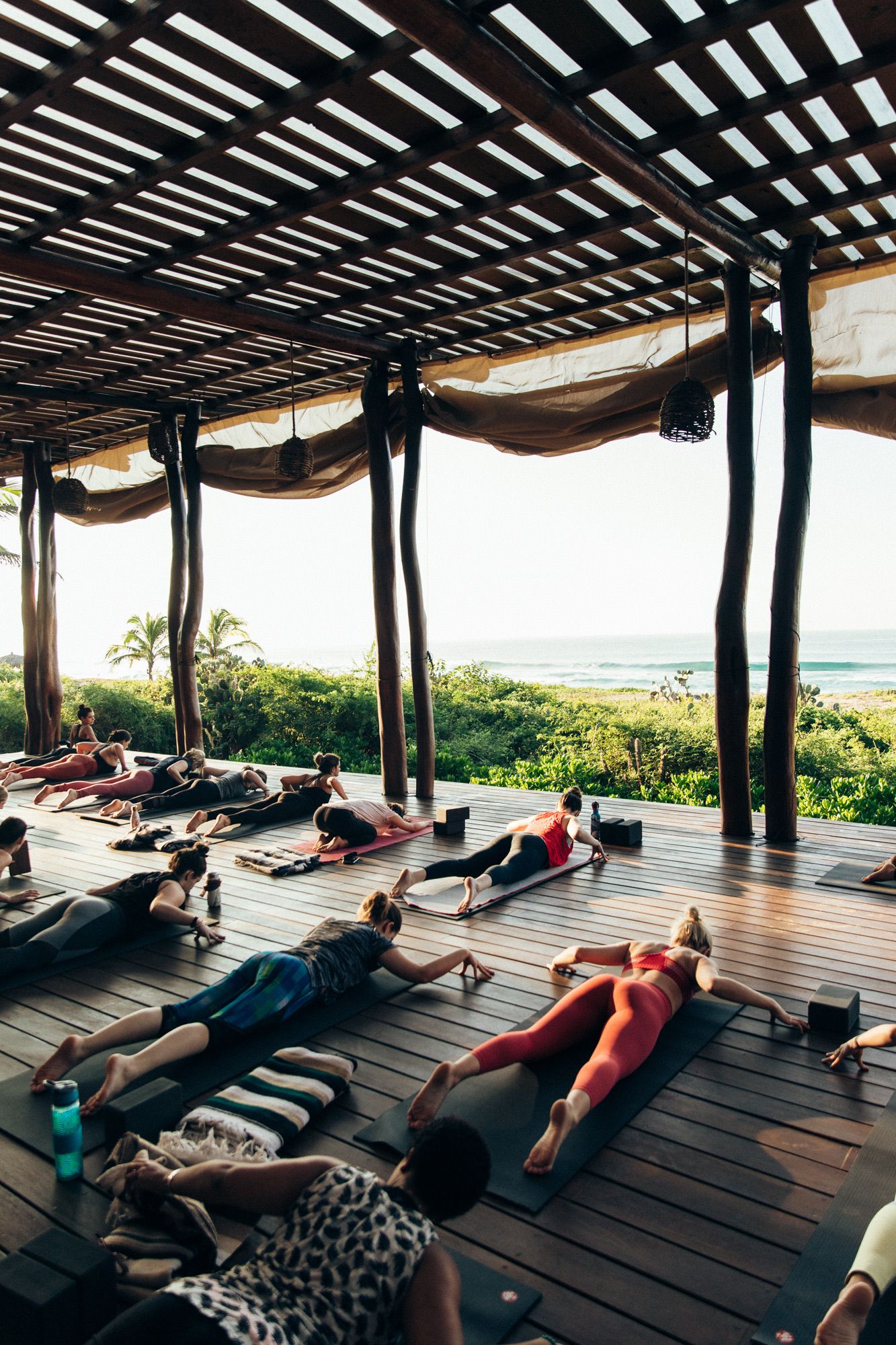 Yoga class in an open-air pavilion facing the sea