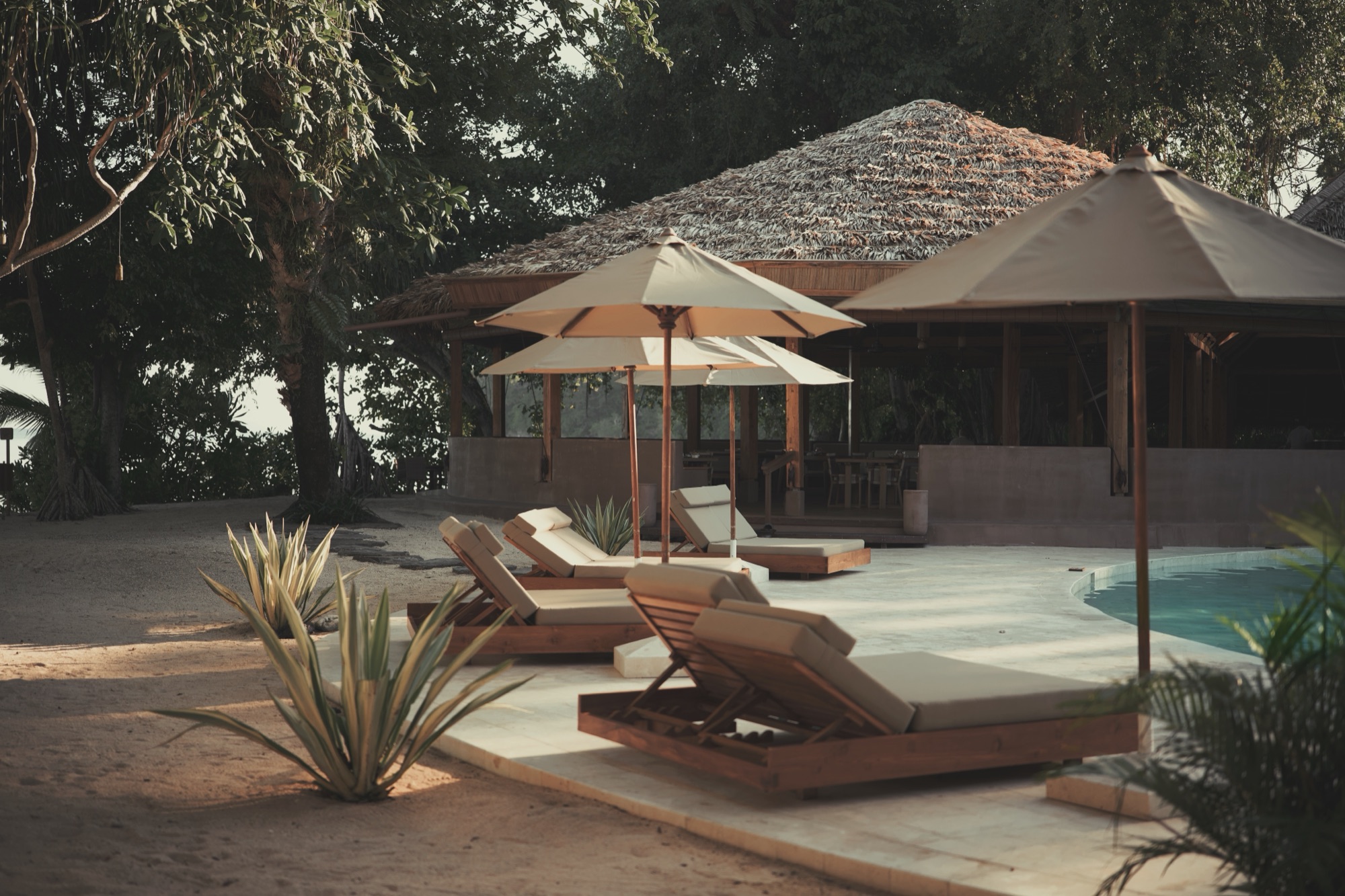 The saltwater pool and thatched pavilions at Siladen Resort