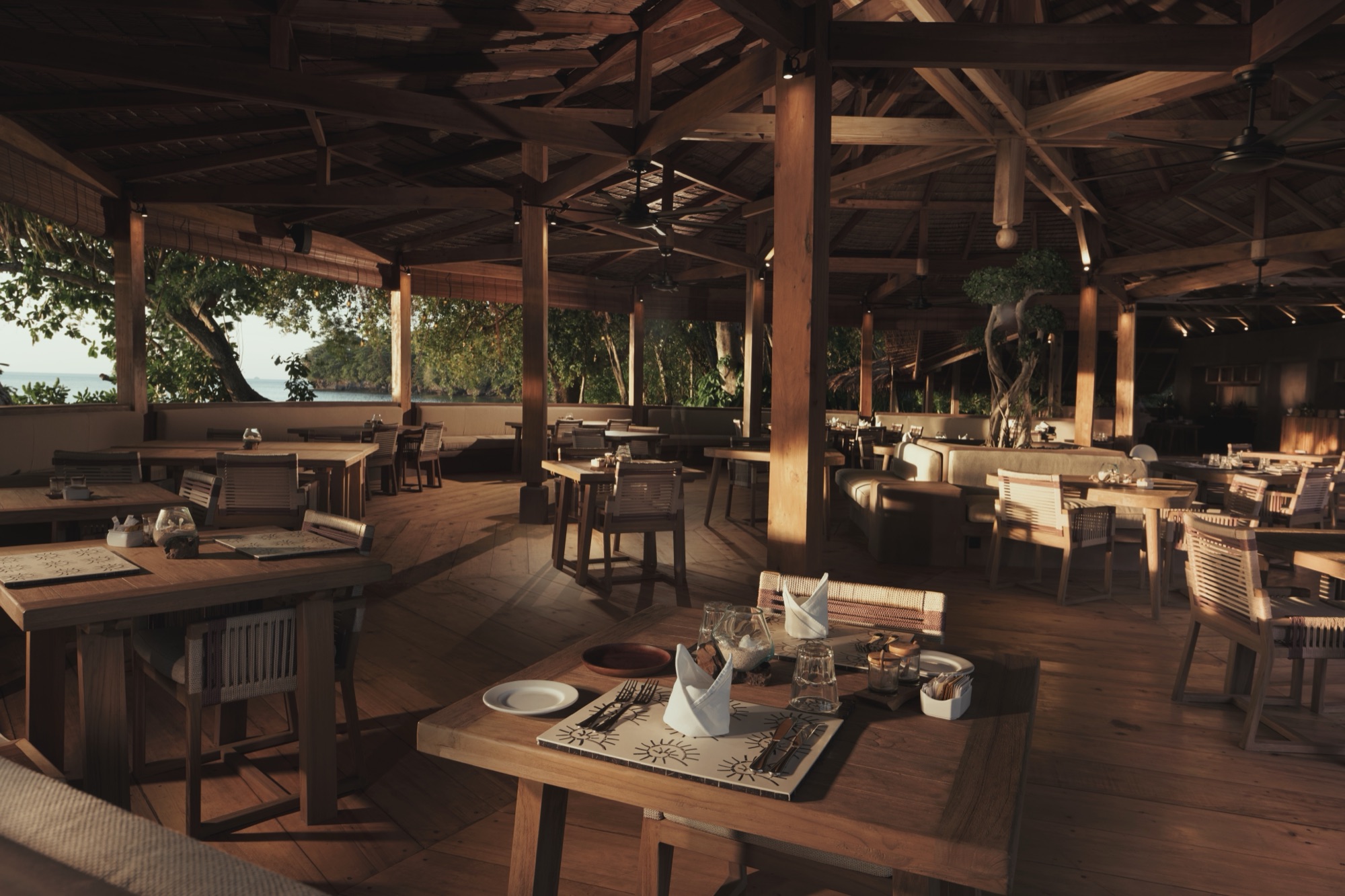 Beachside dining under the trees at Siladen Resort