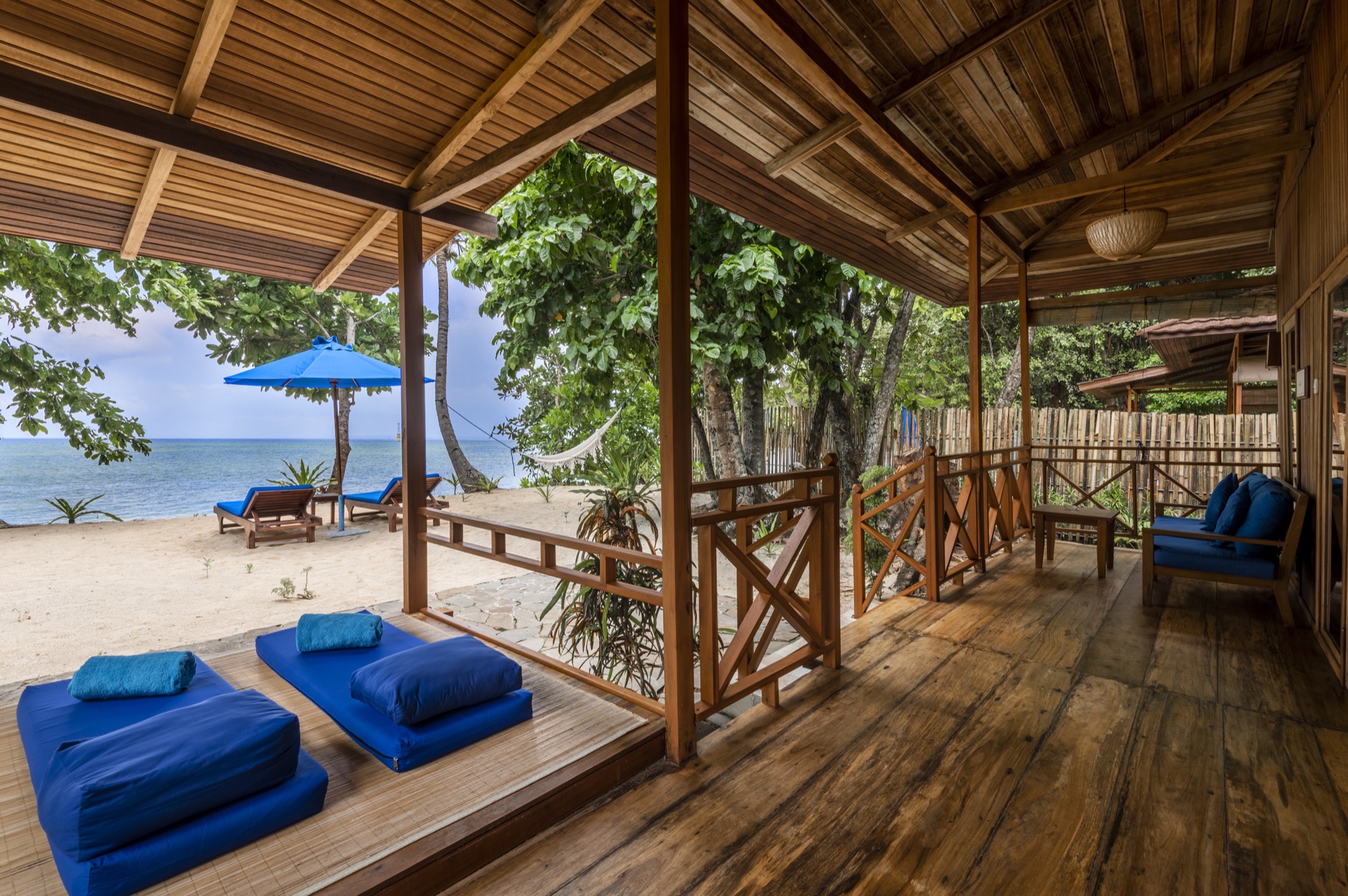 Beach Villa interior with a king-size bed at Siladen